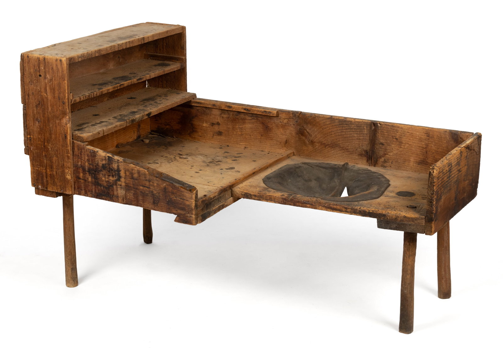 COUNTRY PINE COBBLER'S BENCH: COUNTRY PINE COBBLER'S BENCH, nailed construction, the primitive form with shelves to one end, retaining possibly original leather and a dry, natural surface. Late 19th/first quarter 20th century.