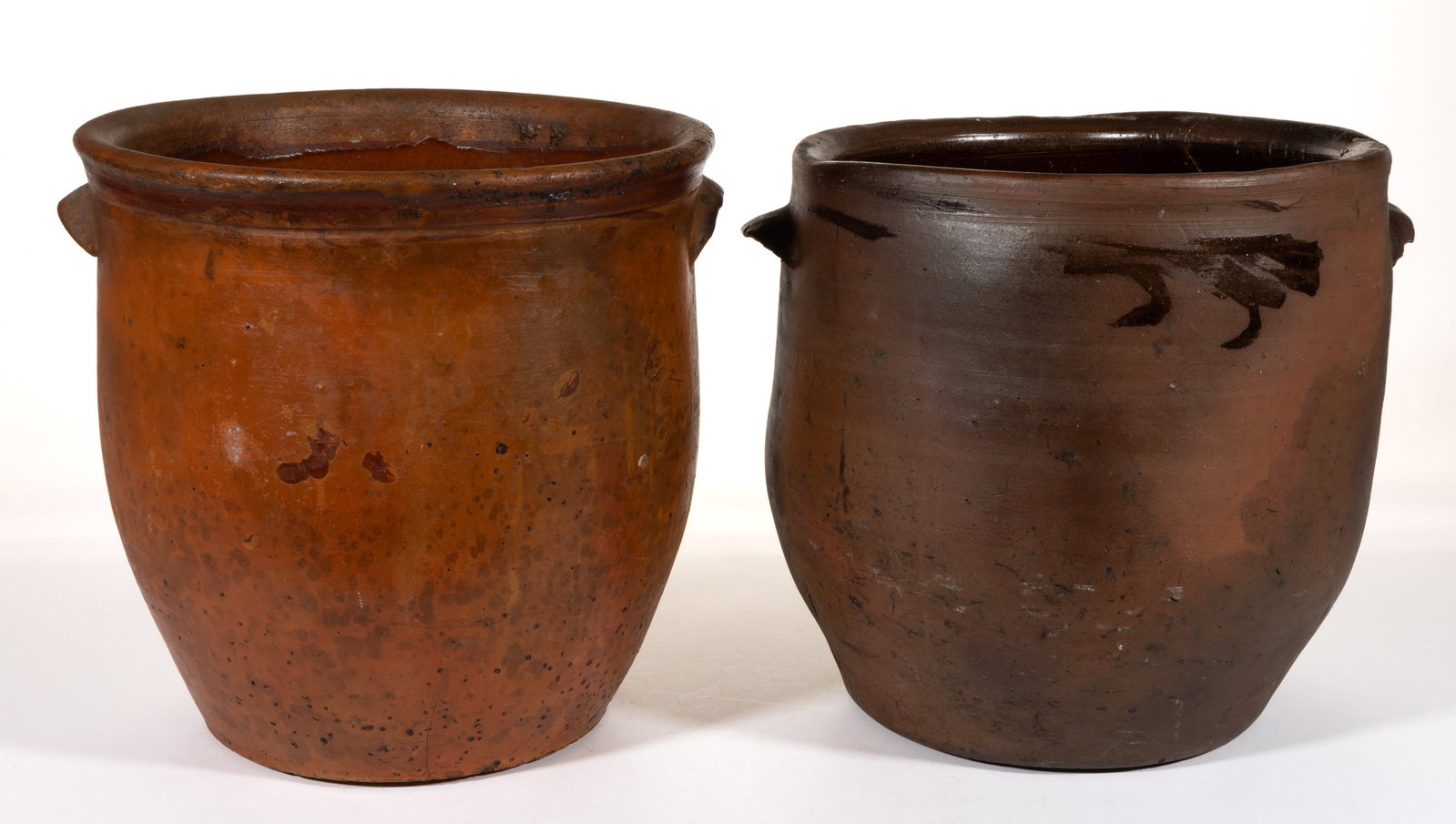 AMERICAN EARTHENWARE / REDWARE JARS, LOT OF TWO: AMERICAN EARTHENWARE / REDWARE JARS, LOT OF TWO, each having single lead-glazed interior, approximately three-gallon capacity, wide-mouth form, and applied arched tab handles, comprising one semi