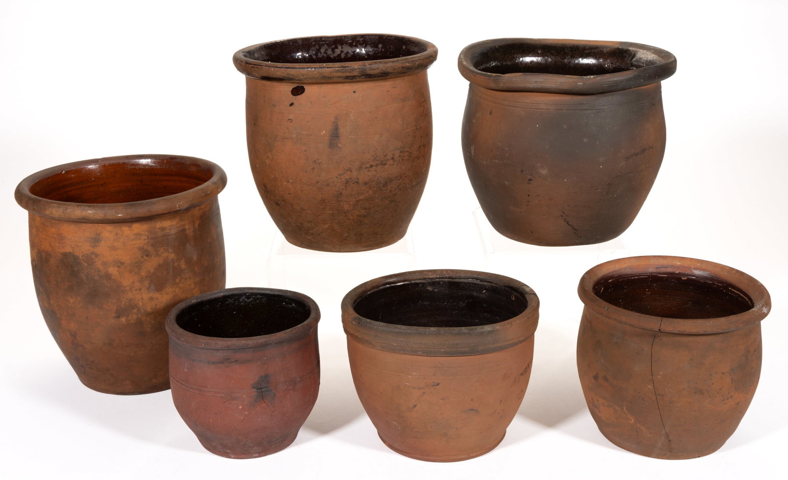 AMERICAN EARTHENWARE / REDWARE CROCKS, LOT OF SIX: AMERICAN EARTHENWARE / REDWARE CROCKS, LOT OF SIX, each single-glazed to the interior and of wide-mouth form, comprising one approximately half-gallon capacity example and five examples with