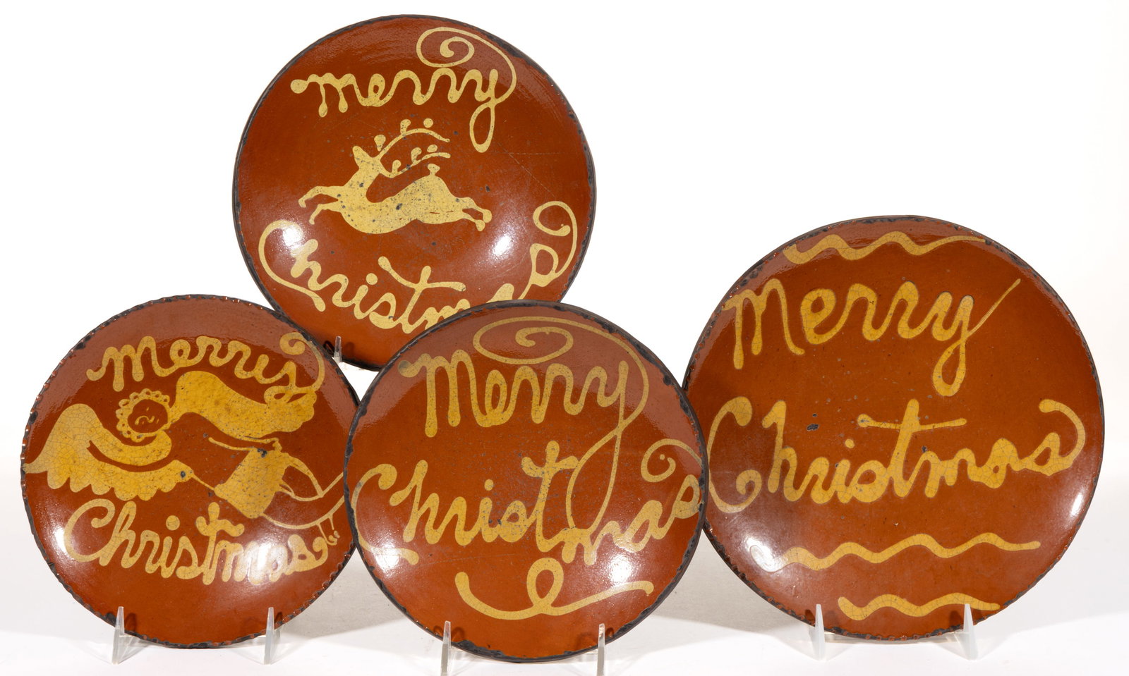 GREG SHOONER (AMERICAN, B. 1953) REPRODUCTION EARTHENWARE / REDWARE CHRISTMAS PANS / PLATES, LOT OF: GREG SHOONER (AMERICAN, B. 1953) REPRODUCTION EARTHENWARE / REDWARE CHRISTMAS PANS / PLATES, LOT OF FOUR, each lead-glazed with slip-trailed inscriptions featuring "Merry / Christmas&qu