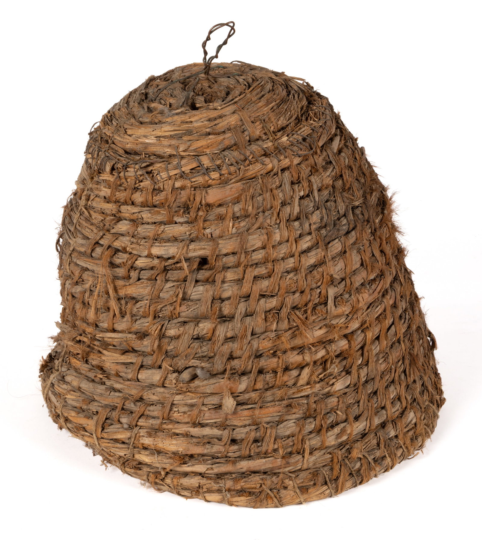COUNTRY COILED-RYE BEE SKEP: COUNTRY COILED-RYE BEE SKEP, of dome form with a later-added wire handle on the top, the interior with cross-members on which the bees construct the hive. Retains remnants of a bee hive on the in