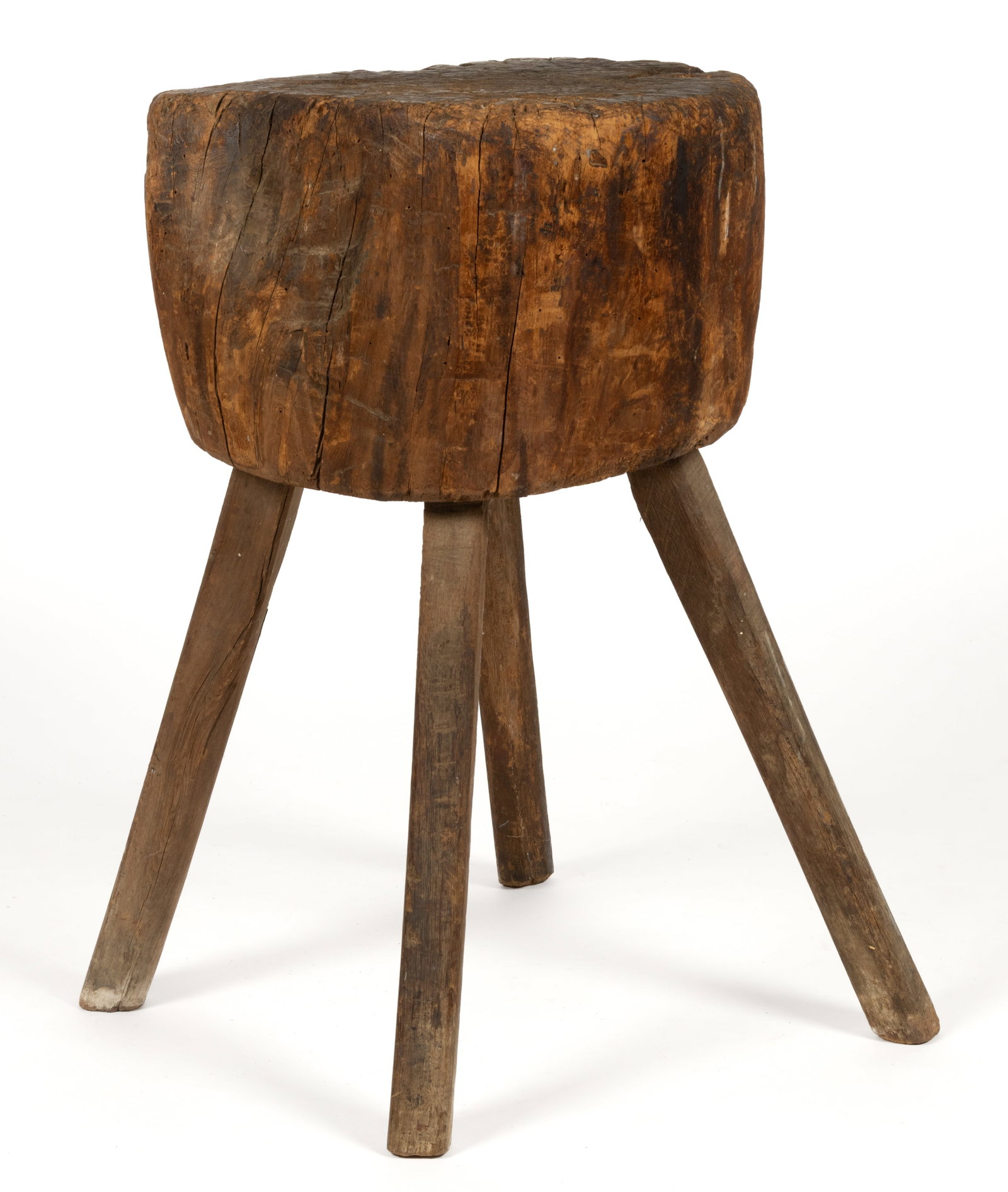 AMERICAN VERNACULAR CHOPPING BLOCK: AMERICAN VERNACULAR CHOPPING BLOCK, the thick block of naturalistic form supported by three splayed legs. 19th century. 28 1/2" HOA, 17 1/2" x 14 1/2" top. Provenance: The estate collec