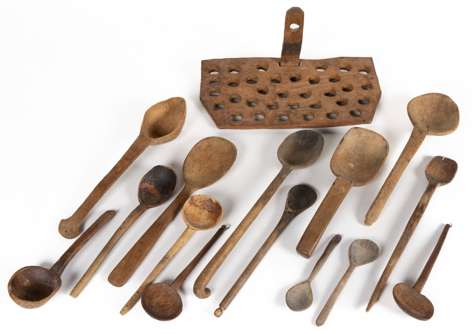 ASSORTED CARVED TREENWARE KITCHEN UTENSILS, LOT OF 15: ASSORTED CARVED TREENWARE KITCHEN UTENSILS, LOT OF 15, including ladles, spoons, and paddles/scoops, several having a shaped handle extension and one example having a hook; and including a hanging wal