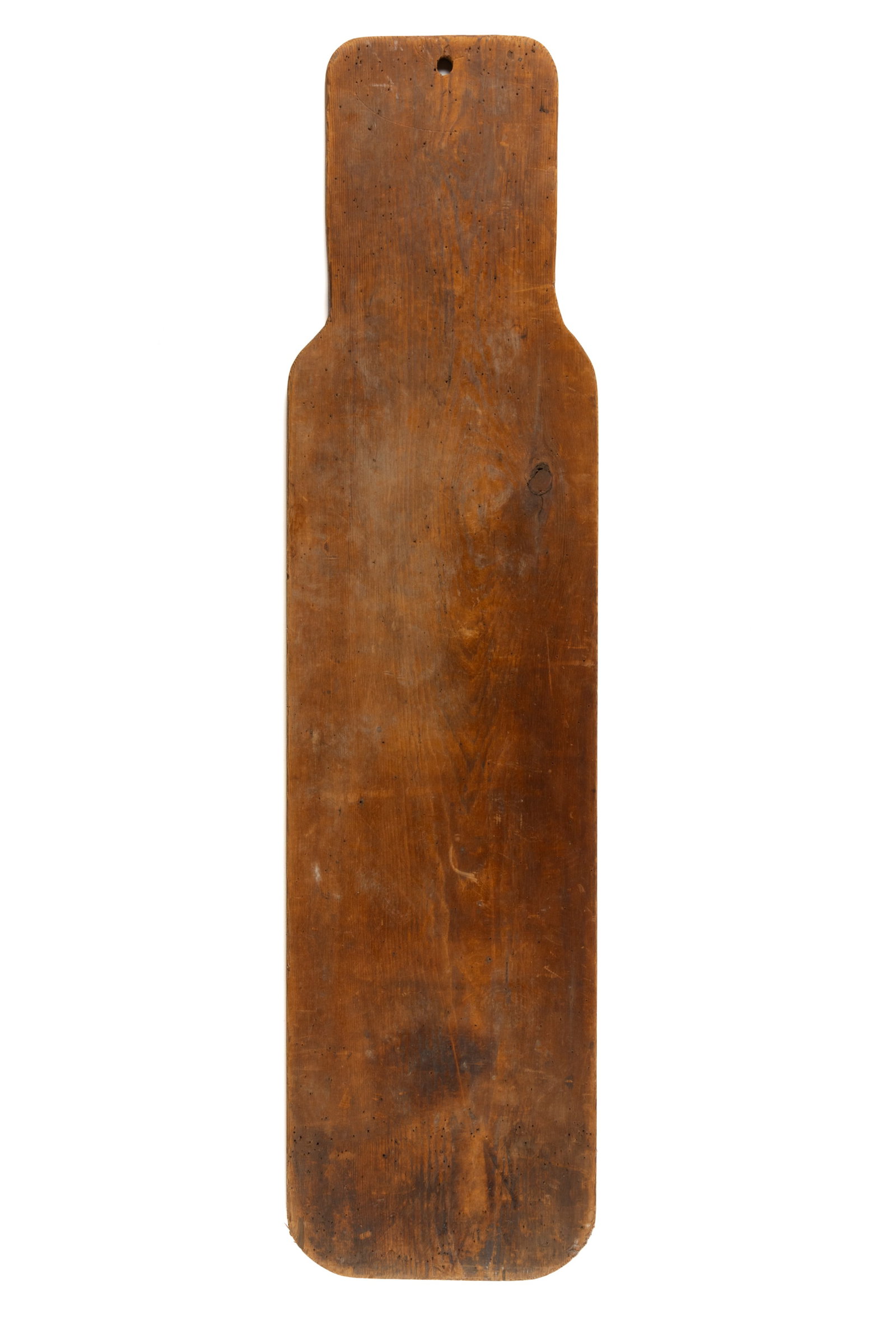 AMERICAN PINE IRONING BOARD: AMERICAN PINE IRONING BOARD, of rectangular single board form with a tapered end having a hanging hole, period nail holes over much of the surface imply that a textile covering was originally att