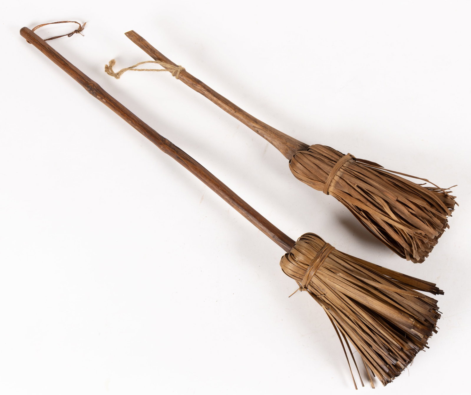 NEW ENGLAND ASH SHAVED / SPLINT DIMINUTIVE HEARTH / TABLE BROOMS, LOT OF TWO: NEW ENGLAND ASH SHAVED / SPLINT DIMINUTIVE HEARTH / TABLE BROOMS, LOT OF TWO, each having a shaven handle and including one with integral construction, one example with a drilled hole and
