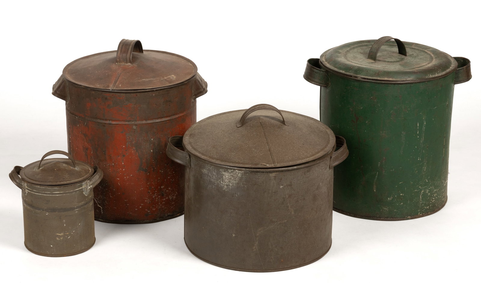 AMERICAN TIN / SHEET-IRON COVERED CANISTERS / CONTAINERS, LOT OF FOUR: AMERICAN TIN / SHEET-IRON COVERED CANISTERS / CONTAINERS, LOT OF FOUR, each of a similar cylindrical form with applied handles and covers with an arched central handle. Retain painted and natural