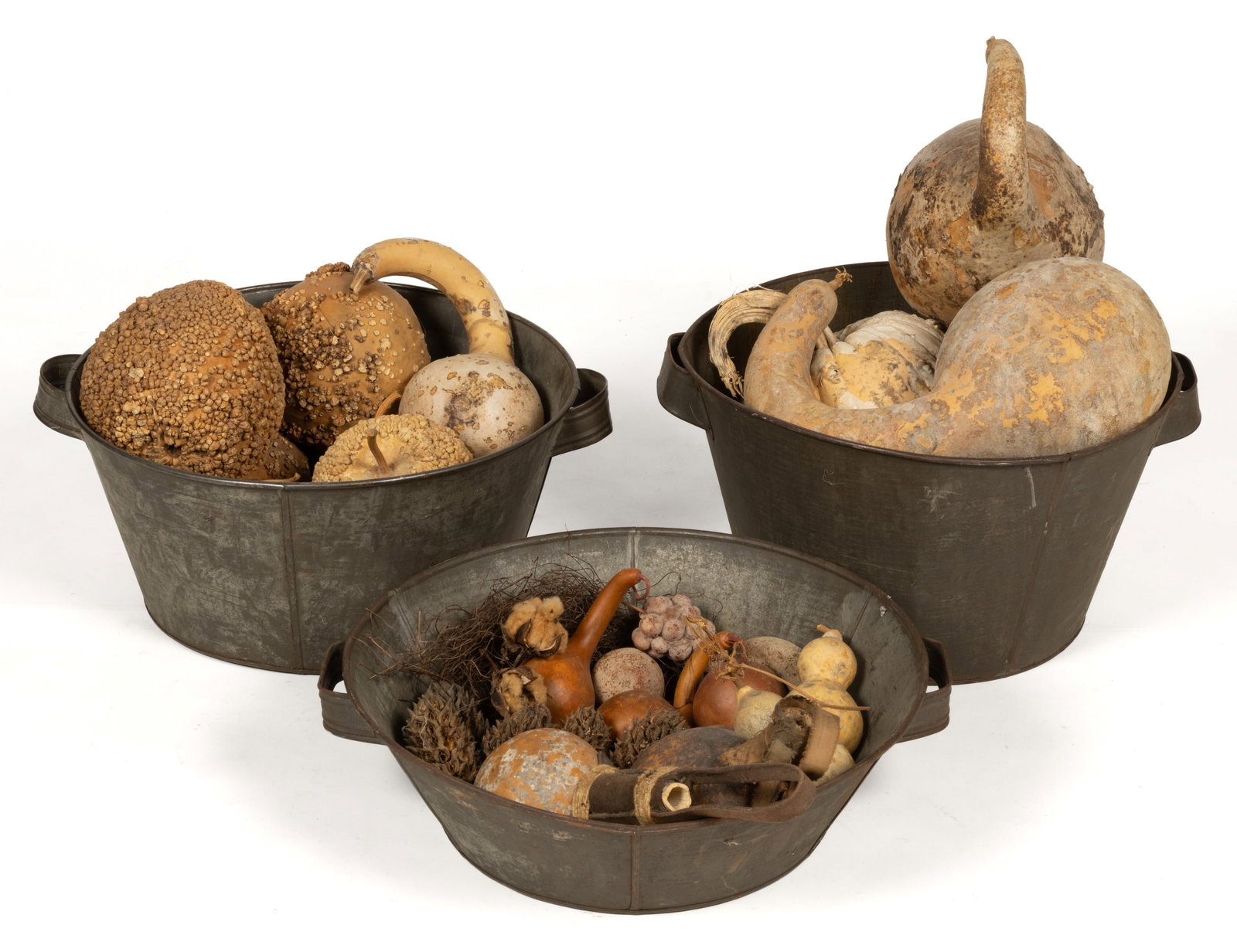 AMERICAN SHEET-IRON / TIN TUBS / PANS WITH DRIED GOURDS, LOT OF THREE: AMERICAN SHEET-IRON / TIN TUBS / PANS WITH DRIED GOURDS, LOT OF THREE, each of similar form with applied handles and old darkened surfaces. Filled with a variety of dried gourds and related decorative