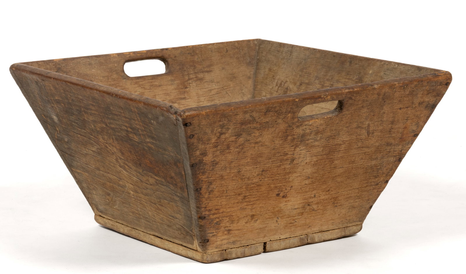 NEW ENGLAND PINE CANTED-SIDE BOX: NEW ENGLAND PINE CANTED-SIDE BOX, nailed-construction, having canted sides with cut-out handles and a base with drilled holes for ventilation or sifting of some kind. Retains the likely original dry