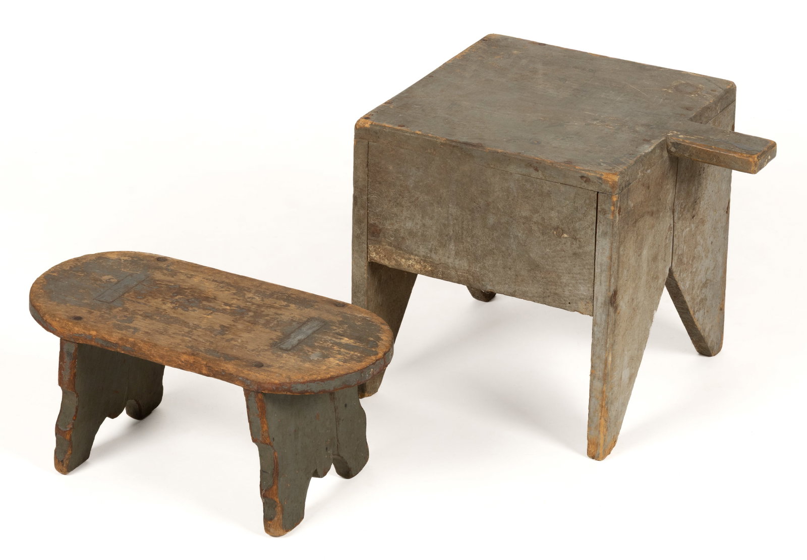 COUNTRY PAINTED PINE STOOLS, LOT OF TWO: COUNTRY PAINTED PINE STOOLS, LOT OF TWO, comprising an example of box form with a projecting handle and cut-out legs; and a small example with ovate top and through-mortised shaped splayed legs.