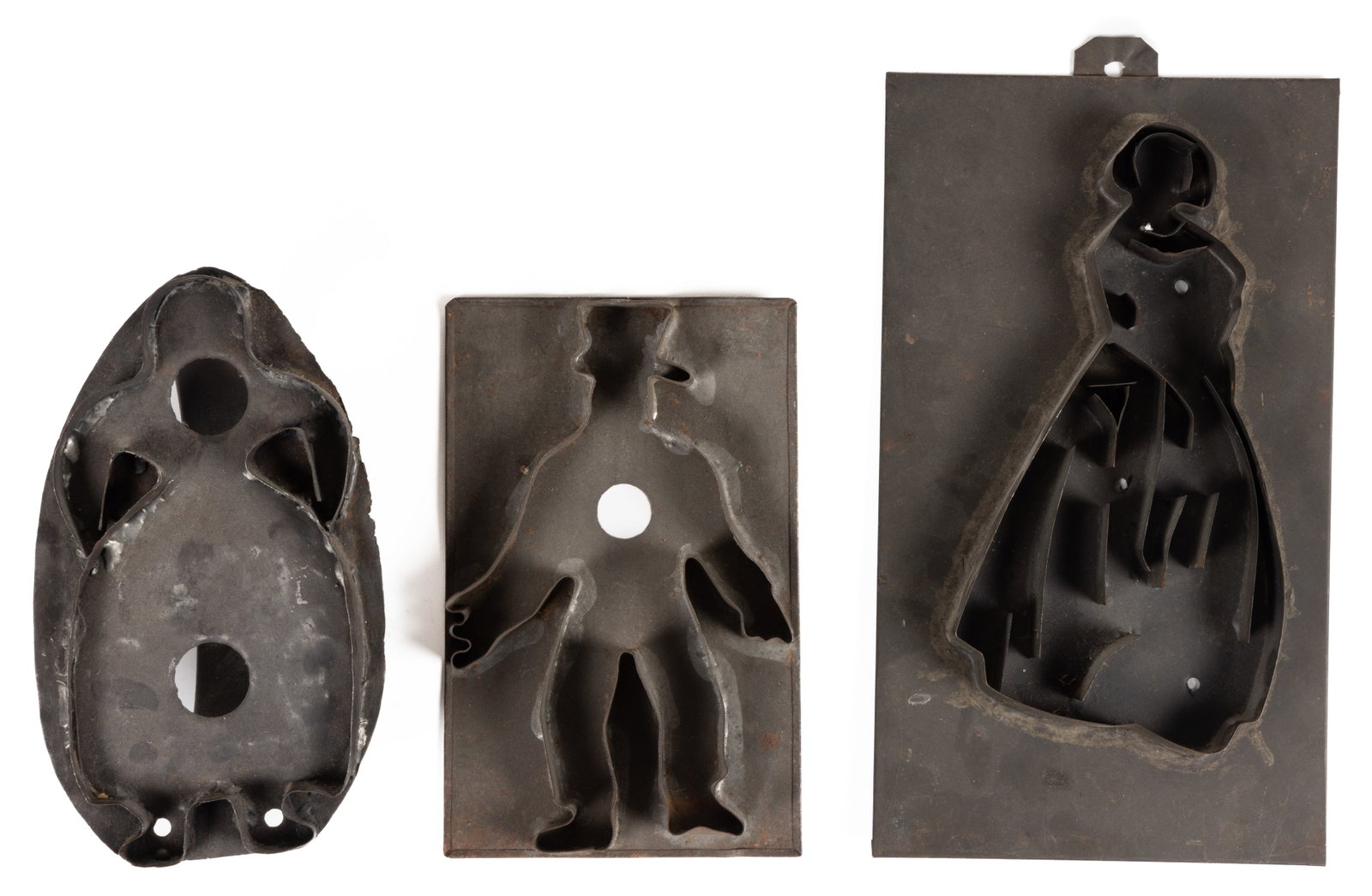AMERICAN SHEET-IRON / TIN FIGURAL COOKIE CUTTERS, LOT OF THREE: AMERICAN SHEET-IRON / TIN FIGURAL COOKIE CUTTERS, LOT OF THREE, each of soldered construction, comprising a large profile figure of a woman with a dress on; a front-facing figure of a woman with 