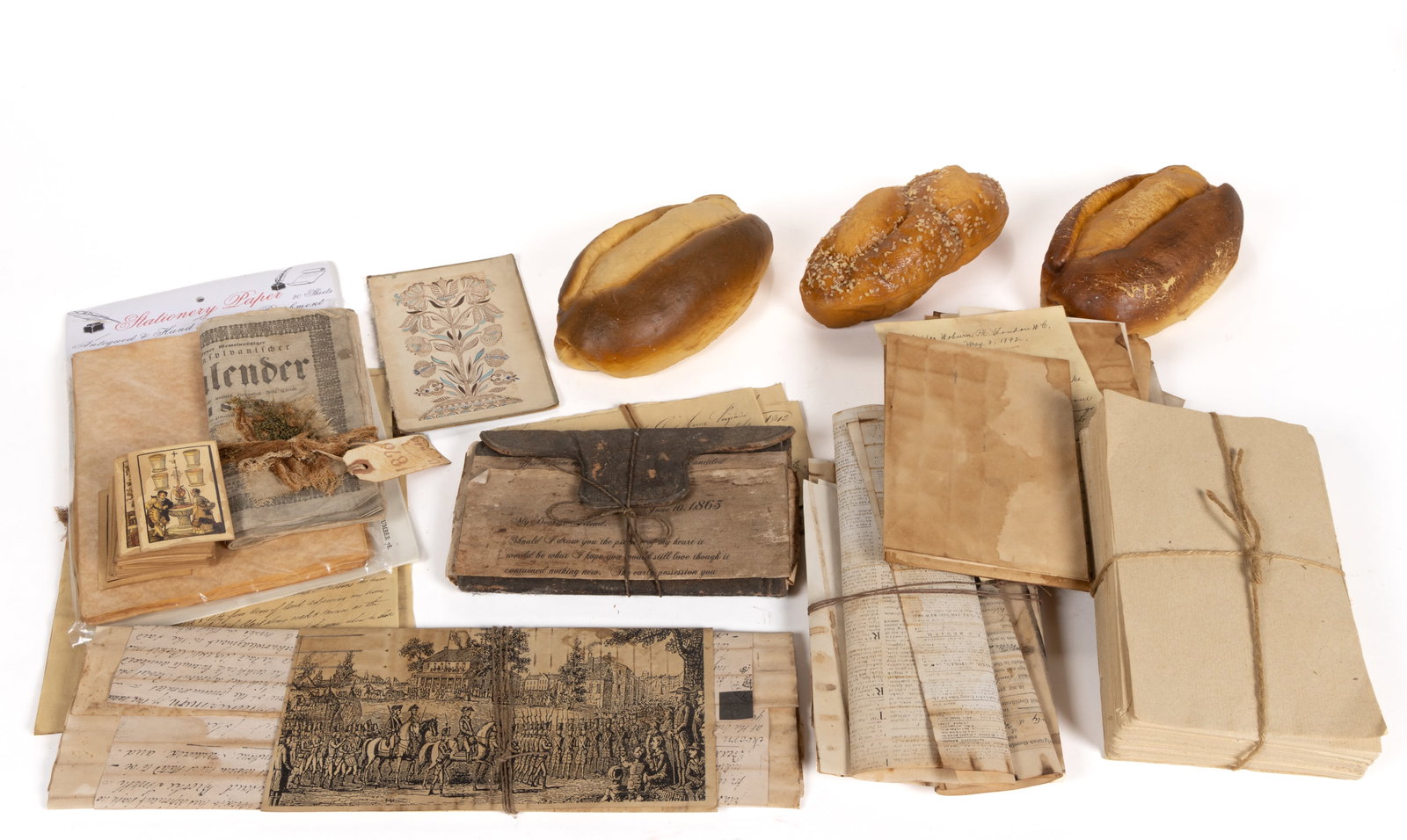 ASSORTED FACSIMILE DOCUMENTS AND OTHER DECORATIVE ARTICLES, UNCOUNTED LOT: ASSORTED FACSIMILE DOCUMENTS AND OTHER DECORATIVE ARTICLES, UNCOUNTED LOT, the paper items used by Mrs. Martin as accessories on desks, etc.; along with three faux loaves of bread. 20th/21st century. 