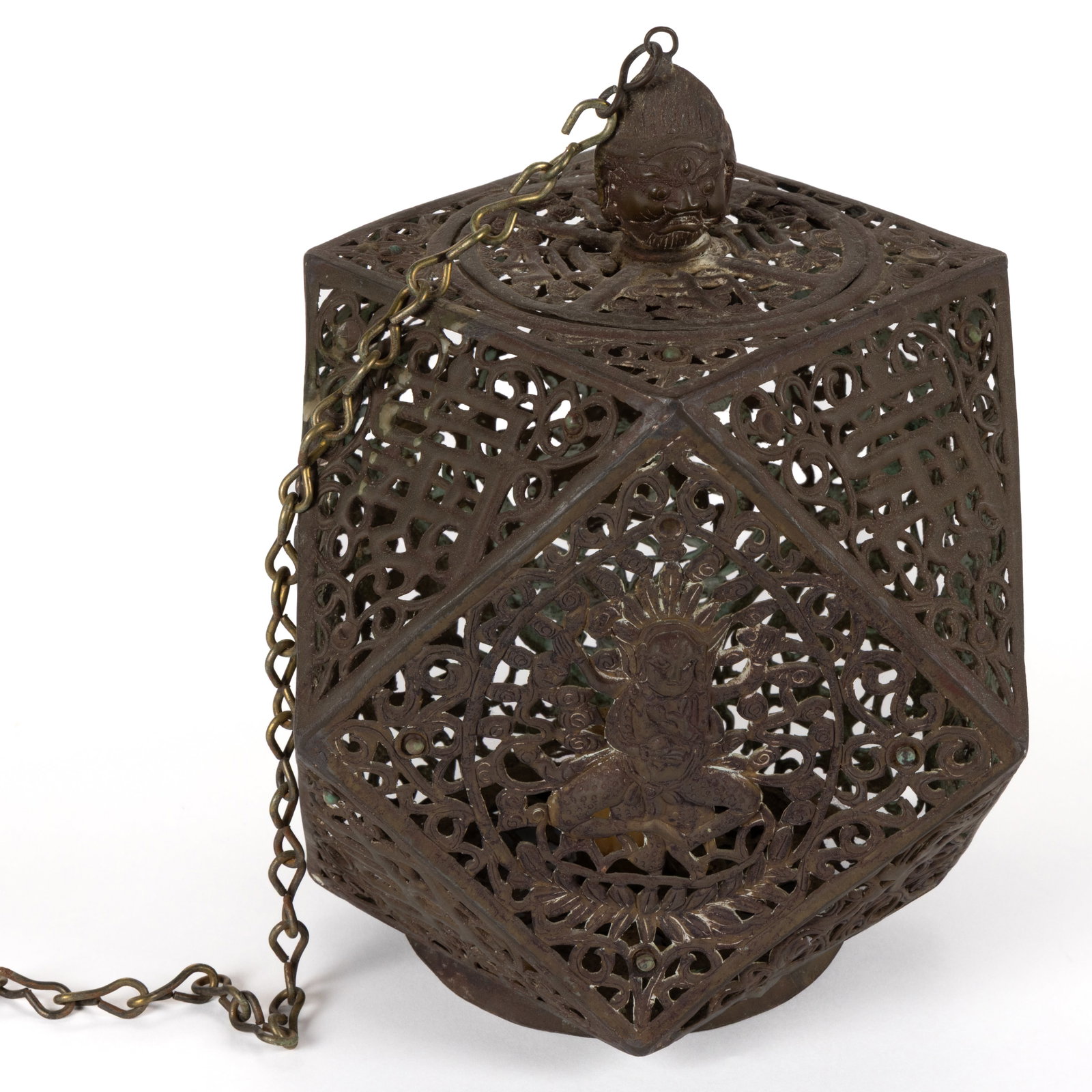 BRASS PERSIAN OPENWORK HANGING CANDLE LANTERN: BRASS PERSIAN OPENWORK HANGING CANDLE LANTERN, overall openwork pattern having a polyhedral form, mid-section with large panels and each having a figural character, topped with a cover having a figura