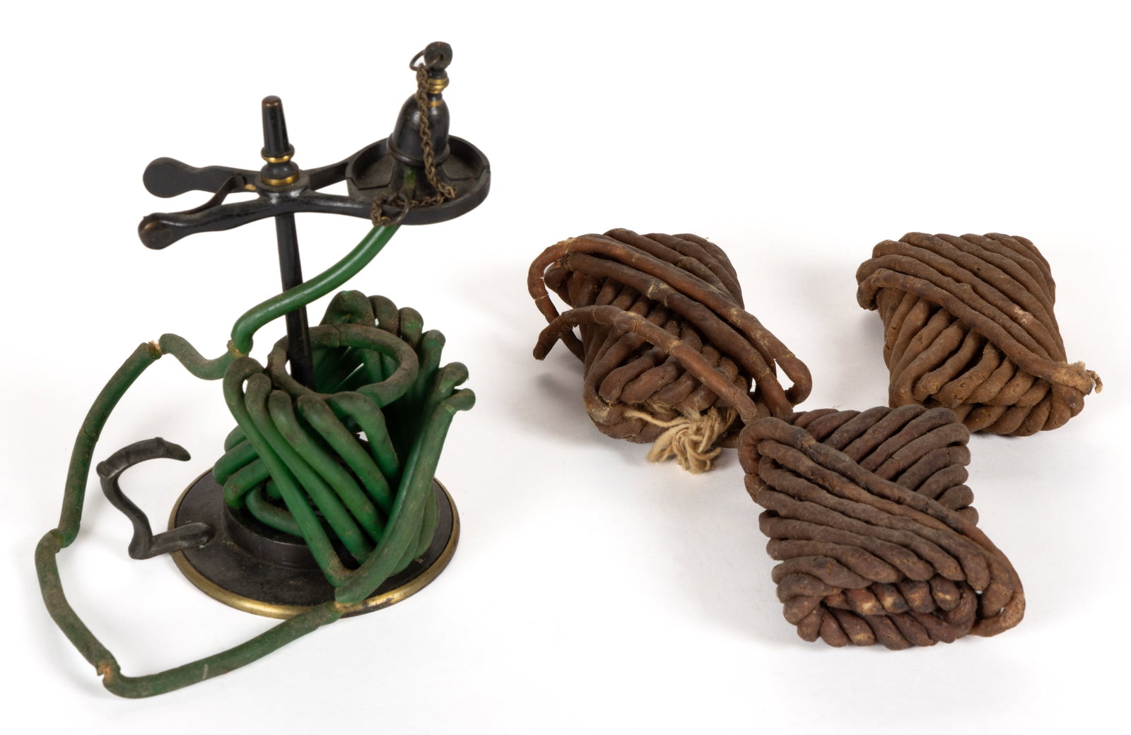 BRASS AND BRONZE TAPER WAX JACK AND WAX ROLLS, LOT OF FOUR: BRASS AND BRONZE TAPER WAX JACK AND WAX ROLLS, LOT OF FOUR, simple shaft with circular-form flat base with finger handle, top fitted with a scissor-form spring-tension holder, side with original 