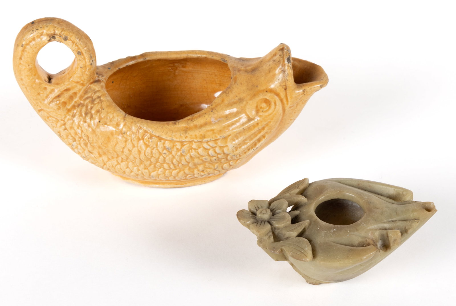 ASSORTED FIGURAL OIL LAMPS, LOT OF THREE: ASSORTED FIGURAL OIL LAMPS, LOT OF THREE, comprising of a ceramic figural fish with a mustard yellow glaze, having a curved tail and open mouth; a carved soapstone/stone example with fl