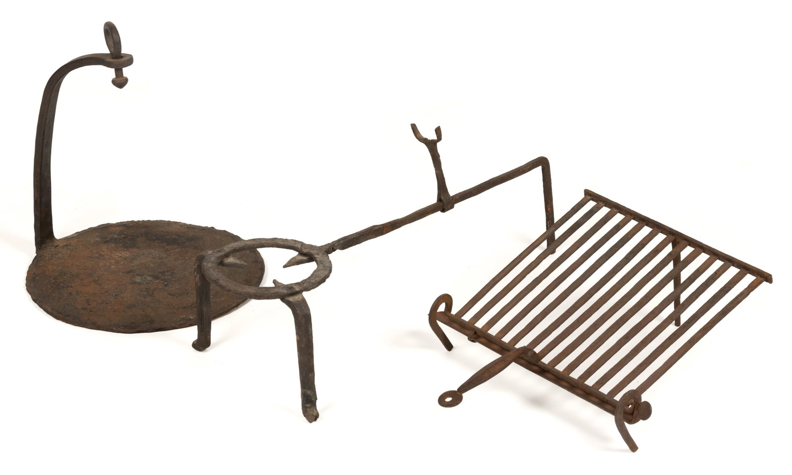 ASSORTED WROUGHT-IRON HEARTH AND FIREPLACE ARTICLES, LOT OF THREE: ASSORTED WROUGHT-IRON HEARTH AND FIREPLACE ARTICLES, LOT OF THREE, comprising of a slanted rectangular-form gridiron/grill, having 13 bars and a drip catch pan, flattened and shaped handle with lollip