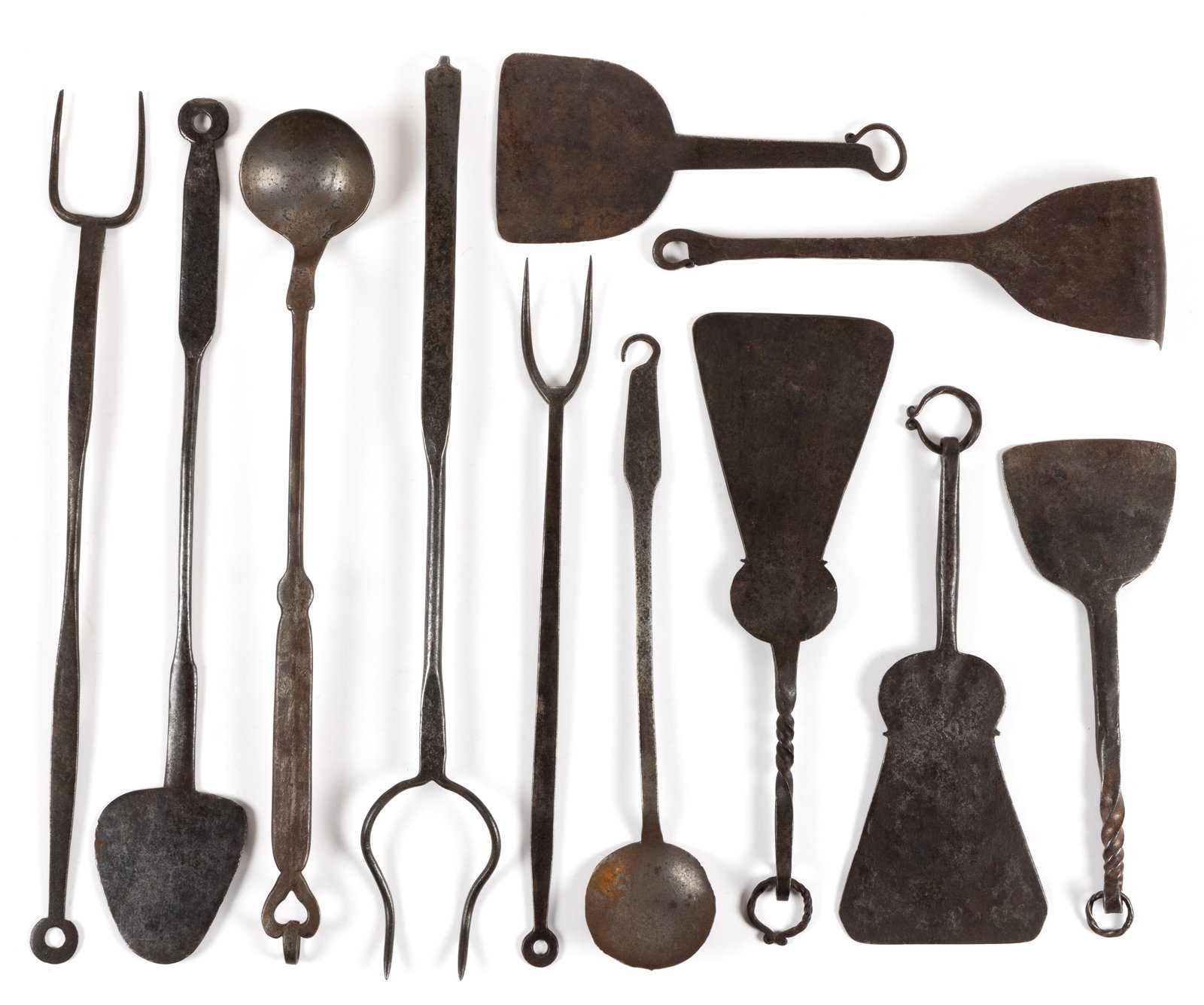 ASSORTED WROUGHT-IRON HEARTH AND FIREPLACE UTENSILS, LOT OF 11: ASSORTED WROUGHT-IRON HEARTH AND FIREPLACE UTENSILS, LOT OF 11, comprising of four food choppers, including two with spiraling patterned handles, each terminating in a loop and including three with a 