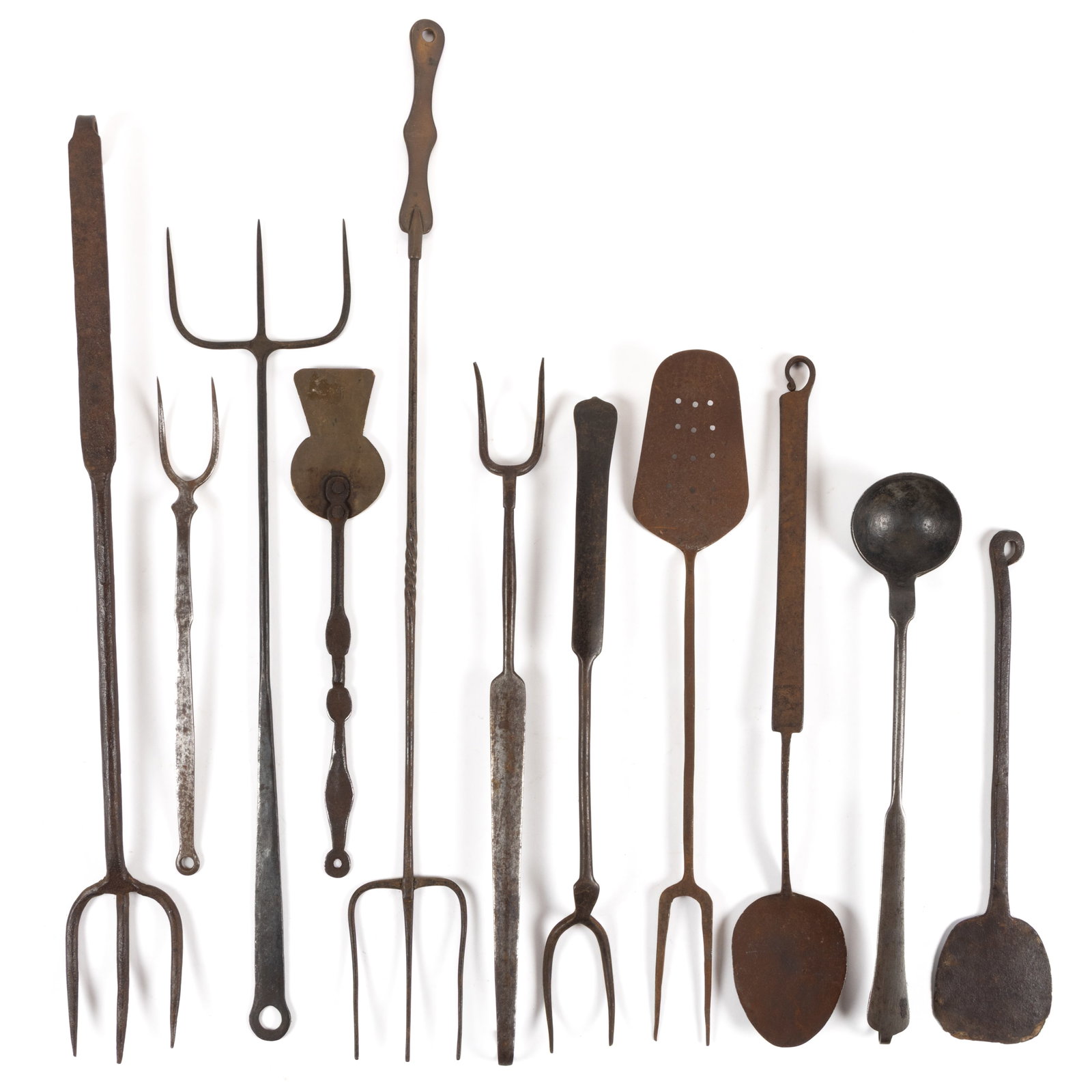 ASSORTED WROUGHT-IRON HEARTH AND FIREPLACE UTENSILS, LOT OF 11: ASSORTED WROUGHT-IRON HEARTH AND FIREPLACE UTENSILS, LOT OF 11, comprising of six flesh forks, including three examples with triple tines, one example having a spiraling handle and shaped brass e