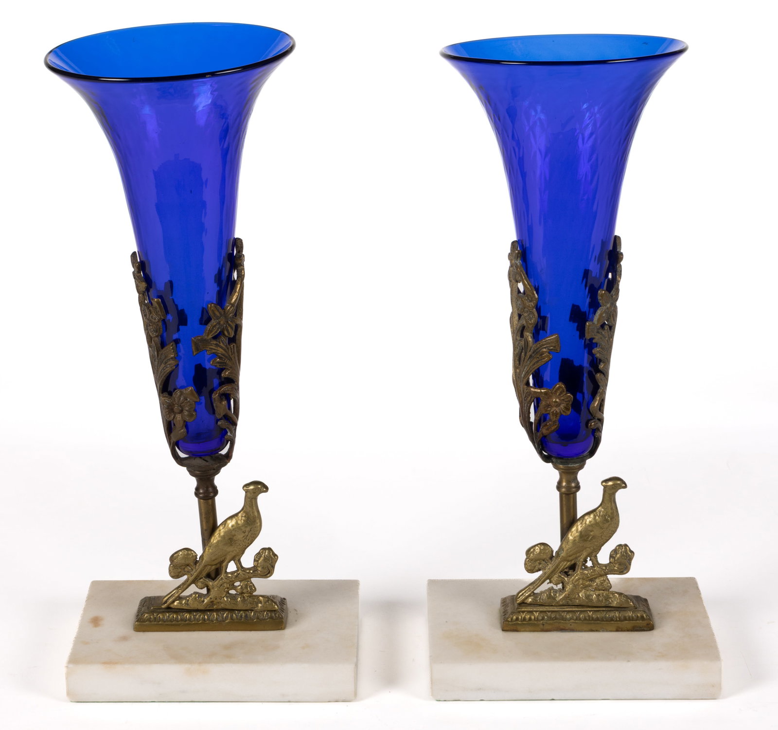 VICTORIAN BRASS AND MARBLE PAIR OF MANTLE VASES: VICTORIAN BRASS AND MARBLE PAIR OF MANTLE VASES, each featuring a cobalt blue diamond-quilted glass insert and a pheasant on the stem. Fourth quarter 19th//first quarter 20th century. 13 1/4" H, 