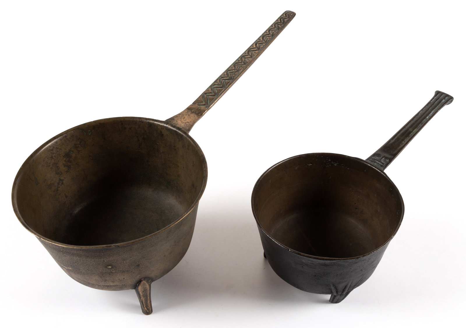 ASSORTED BRONZE BRAZIERS / POSNETS, LOT OF TWO: ASSORTED BRONZE BRAZIERS / POSNETS, LOT OF TWO, each raised on three legs with handle and having a circular-form sprue mark to the underside, comprising of an example having incised initials