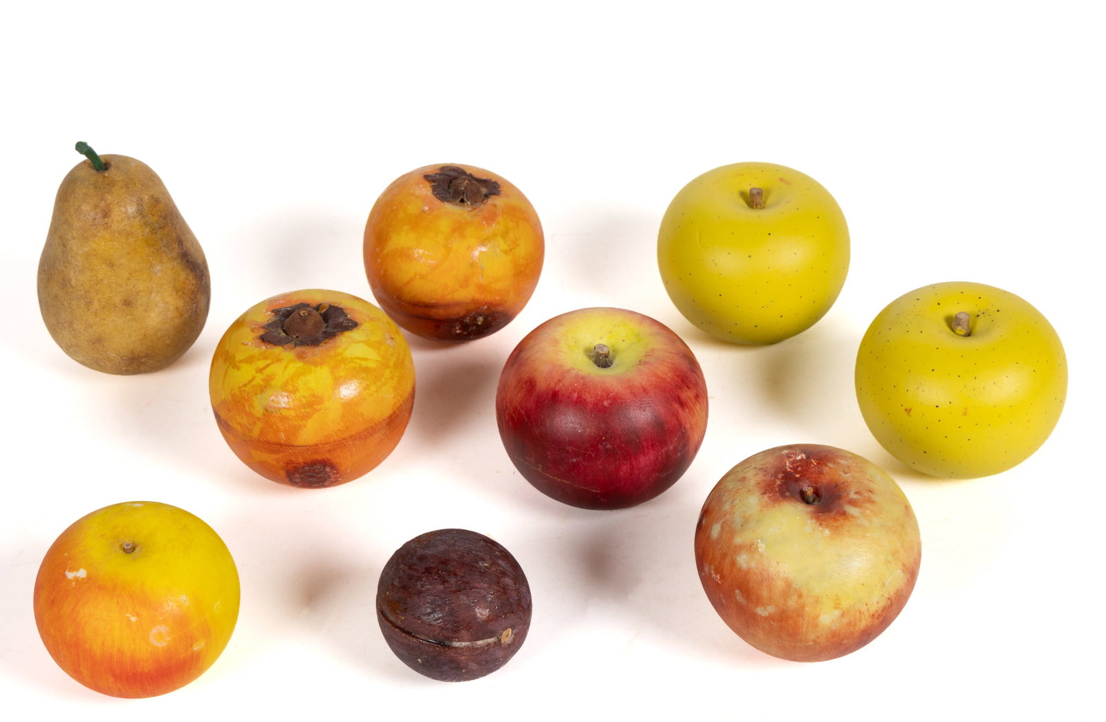 ASSORTED FIGURAL STONE FRUIT, LOT OF NINE: ASSORTED FIGURAL STONE FRUIT, LOT OF NINE, each having naturalistic polychrome decoration, comprising of three red applies, two yellow apples, two pomegranates, a pear, and a plum. 20th