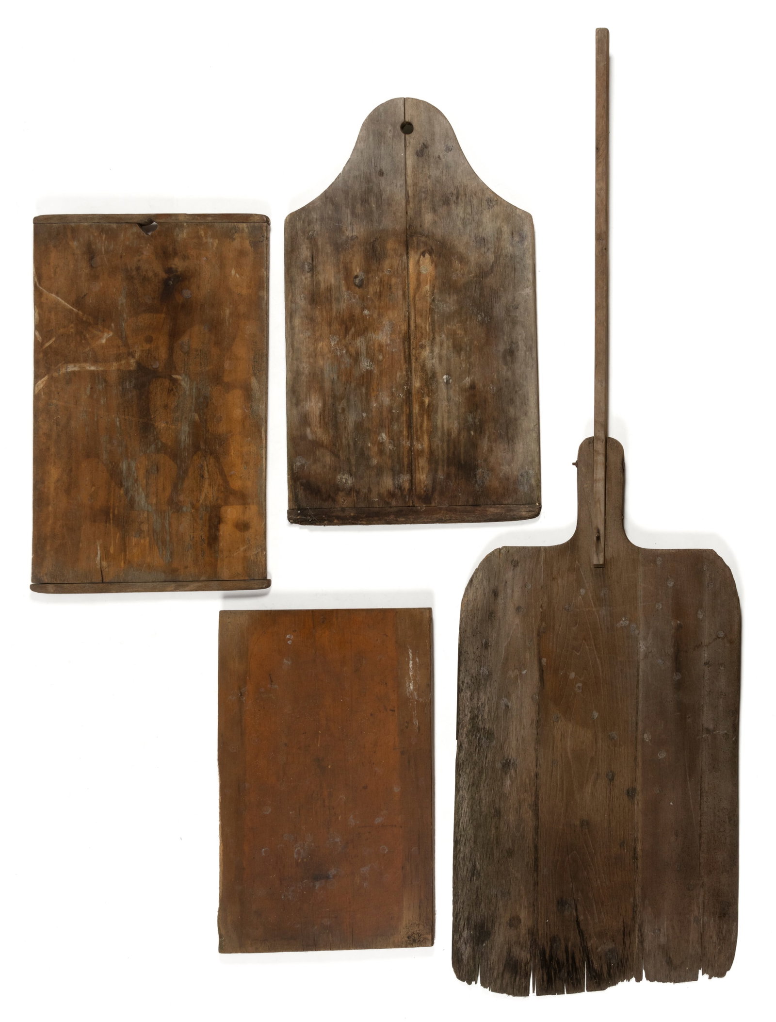 ASSORTED AMERICAN TREEN BREADBOARDS AND PEEL, LOT OF FOUR: ASSORTED AMERICAN TREEN BREADBOARDS AND PEEL, LOT OF FOUR, comprising three breadboards, two of rectangular form, one with an arched top; and a large peel with an extended handle. Each retaining a lig