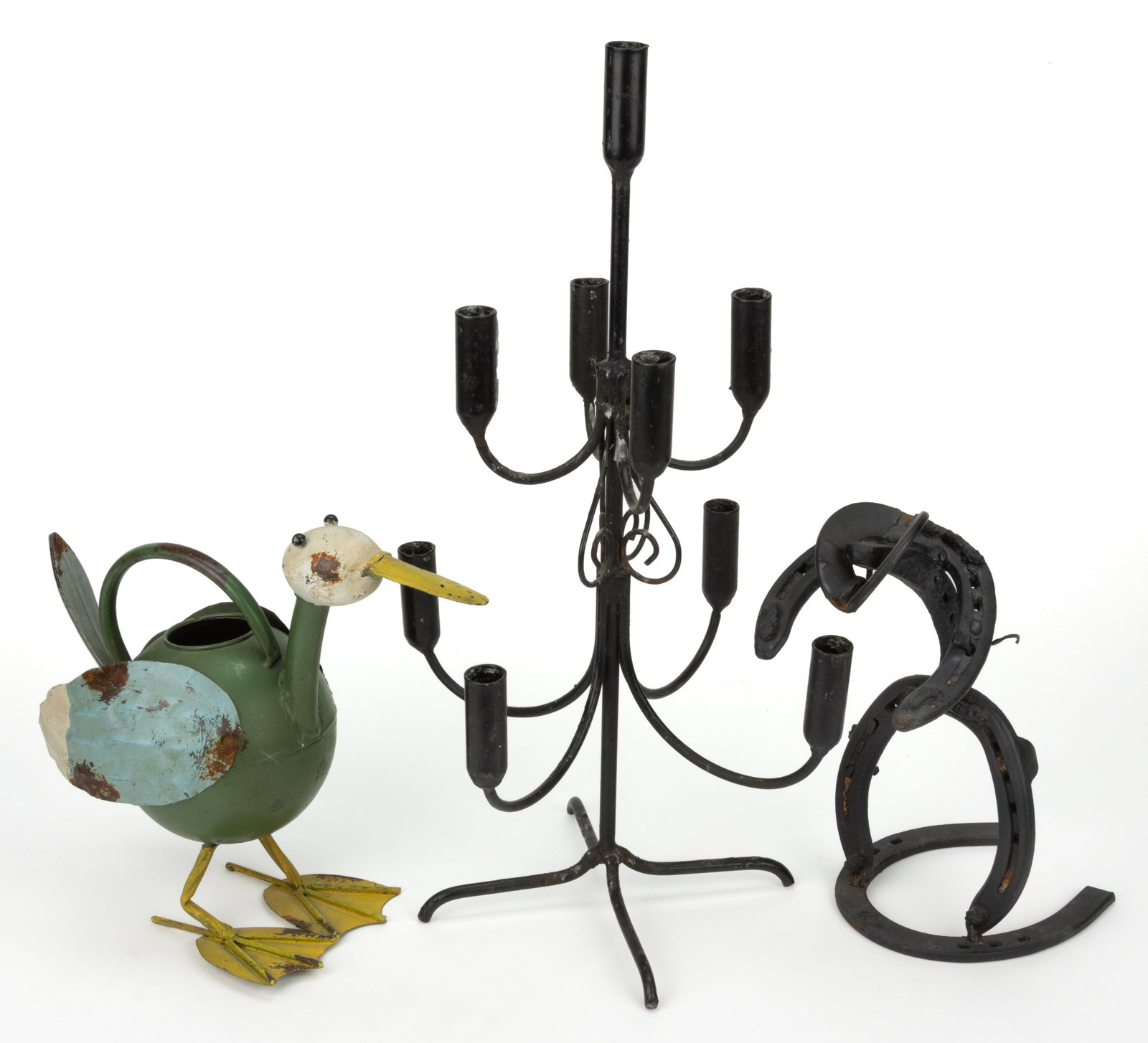 ASSORTED FOLK ART METAL ARTICLES, LOT OF THREE: ASSORTED FOLK ART METAL ARTICLES, LOT OF THREE, comprising a figure of a cowboy made from horseshoes, a Zaer Ltd. duck watering can, and an iron candelabrum. 20th/21st century. Tallest 20 1/2" HO
