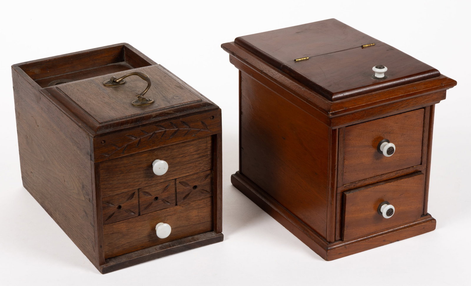 AMERICAN COUNTRY WOODEN BALLOT BOXES, LOT OF TWO: AMERICAN COUNTRY WOODEN BALLOT BOXES, LOT OF TWO, comprising one two-drawer example with a voting compartment in the back and an attached handle at the top; the front has leaf and geometric carving