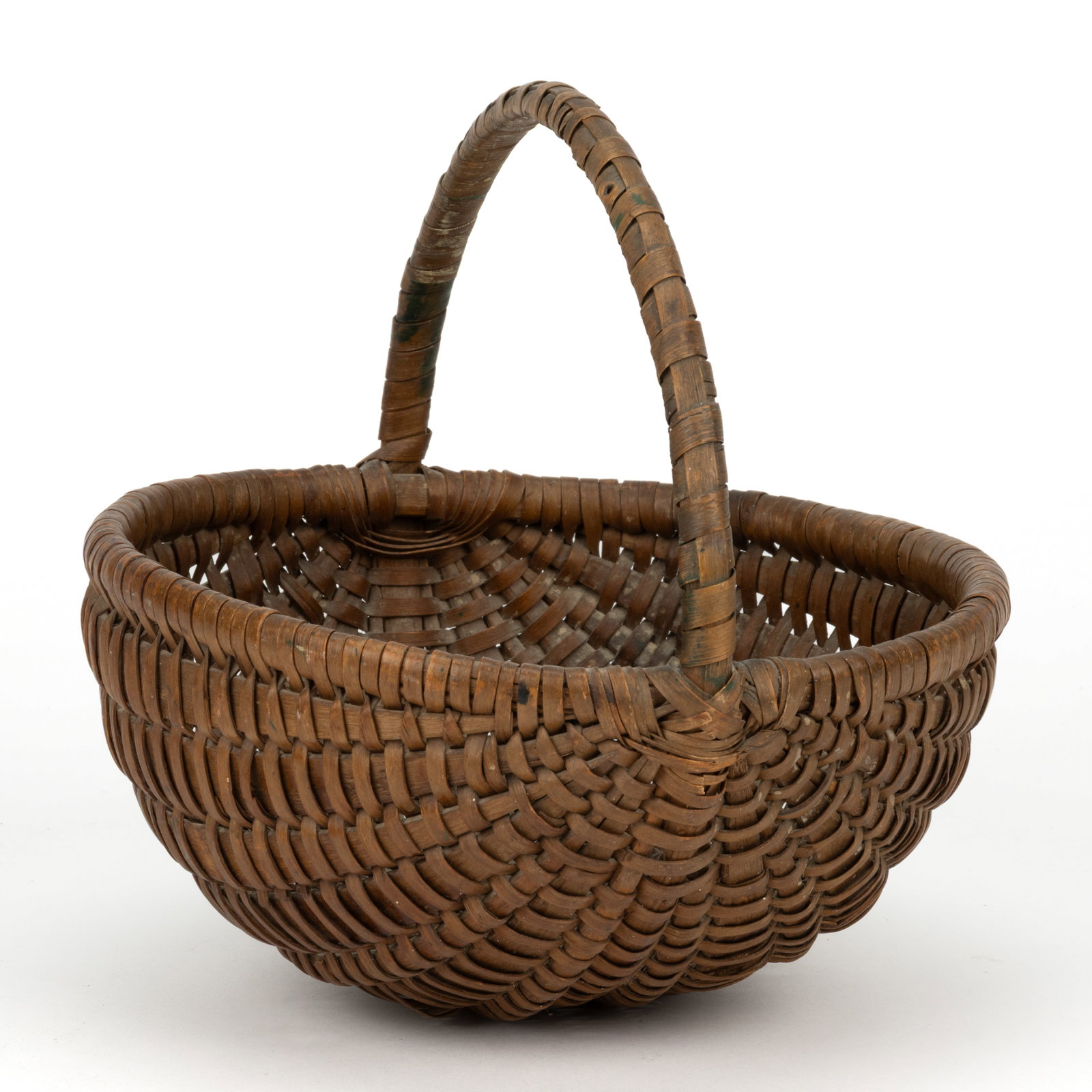 PENNSYLVANIA RIB-TYPE WOVEN-SPLINT MELON BASKET: PENNSYLVANIA RIB-TYPE WOVEN-SPLINT MELON BASKET, ash, of nearly half-round melon form with an arched handle having a plaited decoration and joining the rim with a crossed wrapping. Retains the origina