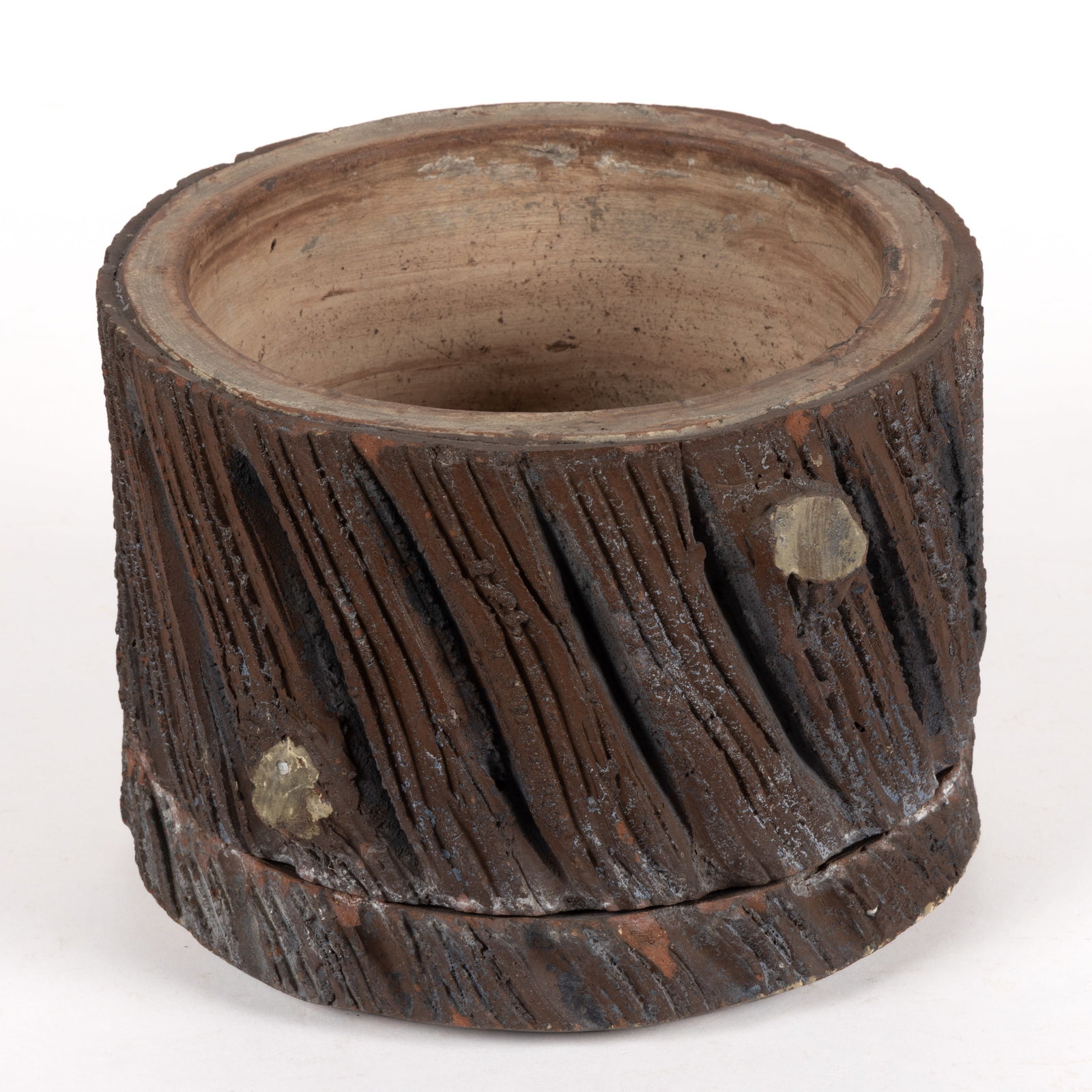 AMERICAN MOLDED SEWER TILE FIGURAL TREE STUMP RUSTIC PLANTER WITH SAUCER: AMERICAN MOLDED SEWER TILE FIGURAL TREE STUMP RUSTIC PLANTER WITH SAUCER, circular form having four cut branches to textured exterior and a pierced hole to bottom of planter for drainage. Late