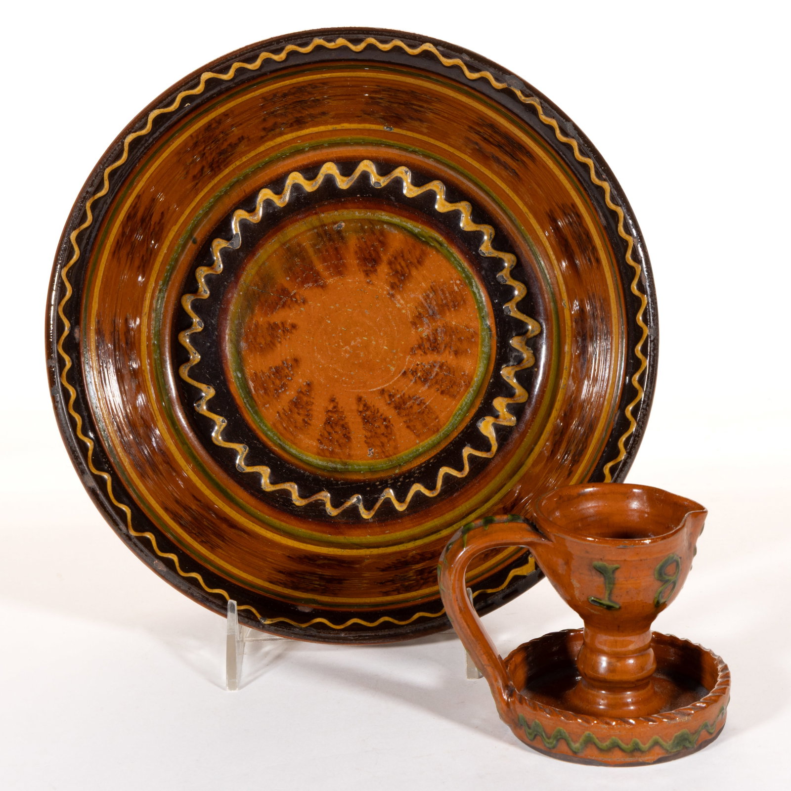 GREG SHOONER (AMERICAN, B. 1953) REPRODUCTION EARTHENWARE / REDWARE ARTICLES, LOT OF TWO: GREG SHOONER (AMERICAN, B. 1953) REPRODUCTION EARTHENWARE / REDWARE ARTICLES, LOT OF TWO, lead-glazed with copper slip decorations, comprising a fat/grease lamp with single-spout and baluste