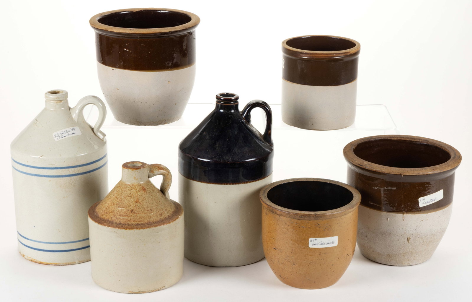 AMERICAN STONEWARE CROCKS AND JUGS, LOT OF SEVEN: AMERICAN STONEWARE CROCKS AND JUGS, LOT OF SEVEN, comprising four examples with Bristol-slip glaze and Albany-slip glazed tops including three wide-mouth crocks and an approximately one-gallon