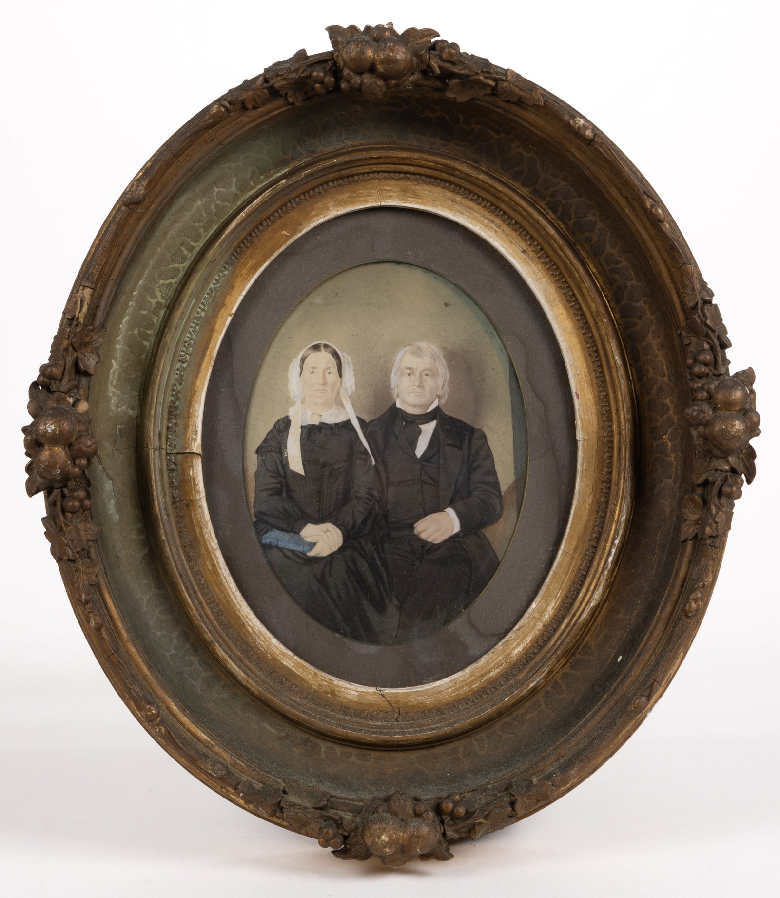 BEDFORD TOWNSHIP, PENNSYLVANIA PHOTOGRAPH OF A MENNONITE COUPLE: BEDFORD TOWNSHIP, PENNSYLVANIA PHOTOGRAPH OF A MENNONITE COUPLE, enhanced with watercolor-painted detailing, depicting a likely-Mennonite couple, she holds a blue book. Housed in a high-quality period