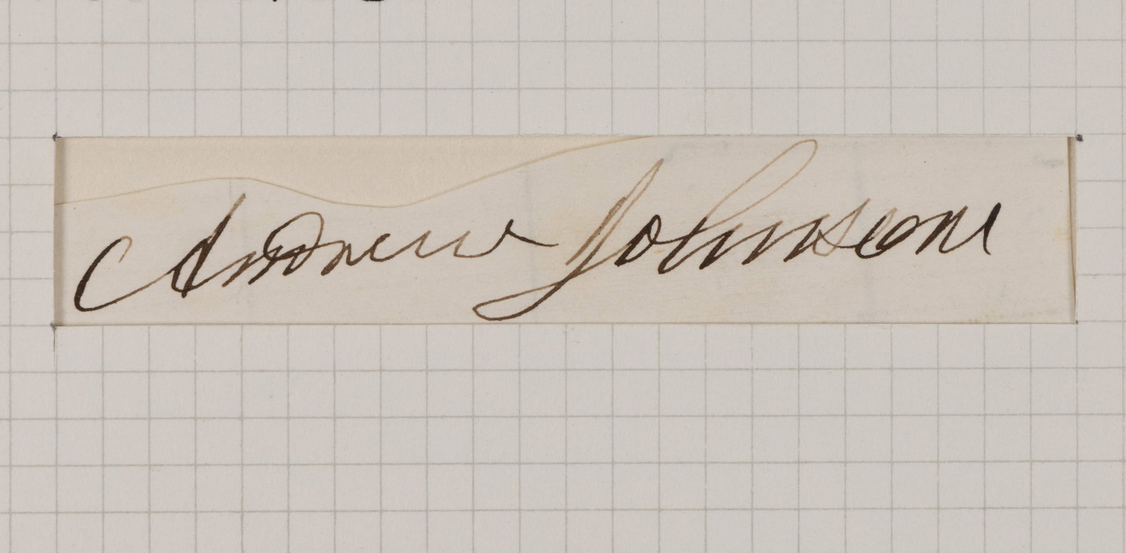 PRESIDENT ANDREW JOHNSON (1808-1875) CLIPPED SIGNATURE: PRESIDENT ANDREW JOHNSON (1808-1875) CLIPPED SIGNATURE, on lightly lined paper, in a folder mounted with a 17-cent postage stamp. 10 1/4" x 8 1/4" sheet. 
