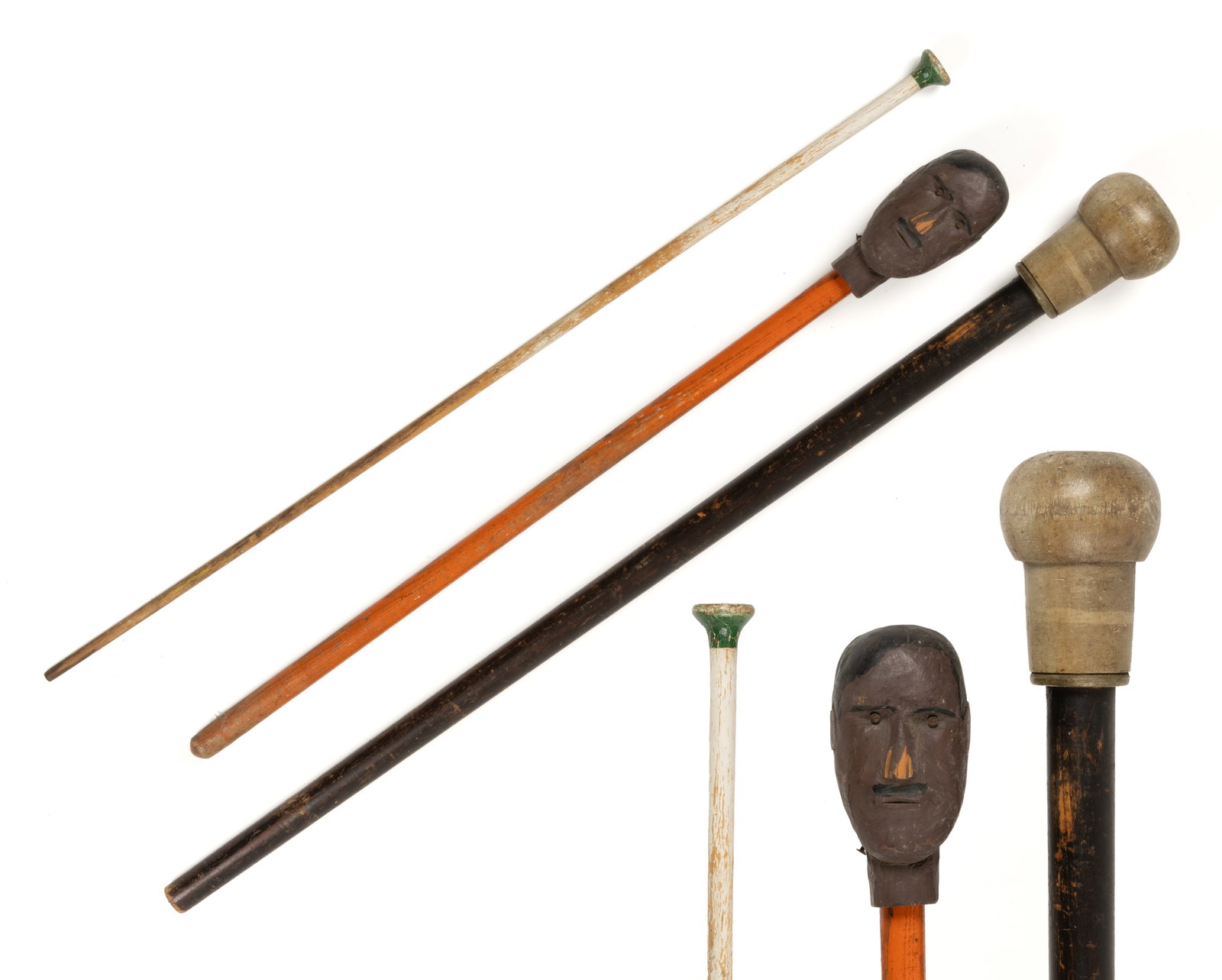 AMERICAN FOLK ART CARVED AND PAINTED PARADE BATONS / CARNIVAL CANES, LOT OF THREE: AMERICAN FOLK ART CARVED AND PAINTED PARADE BATONS / CARNIVAL CANES, LOT OF THREE, comprising an example with a man's head as the finial; an example with a robust turned finial; and a smaller exam