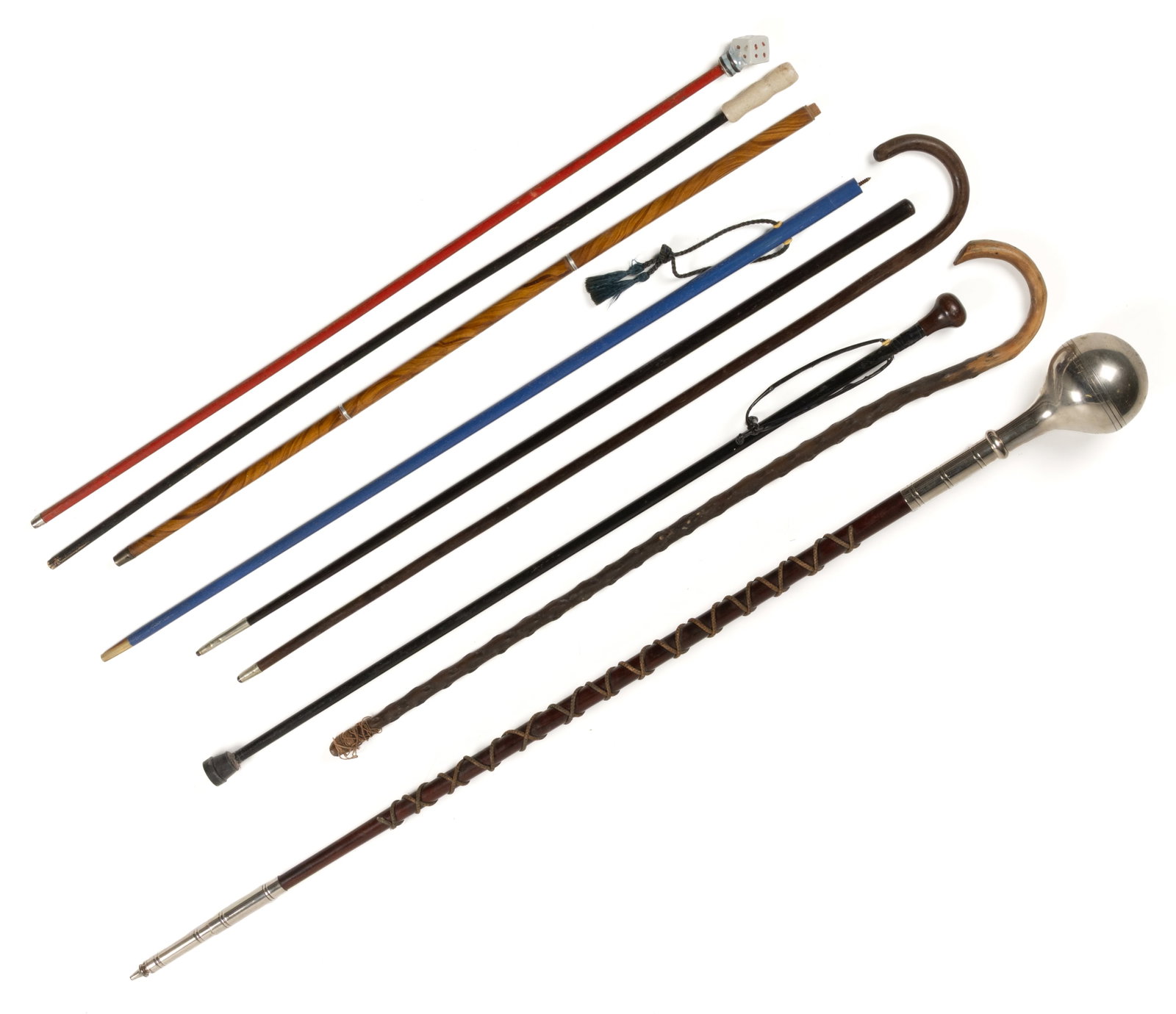 ASSORTED CANES / WALKING STICKS AND RELATED ARTICLES, LOT OF NINE: ASSORTED CANES / WALKING STICKS AND RELATED ARTICLES, LOT OF NINE, including a parade staff of some form, a trick cane with capped glass vials on the interior, and an example with a ceramic dice grip.