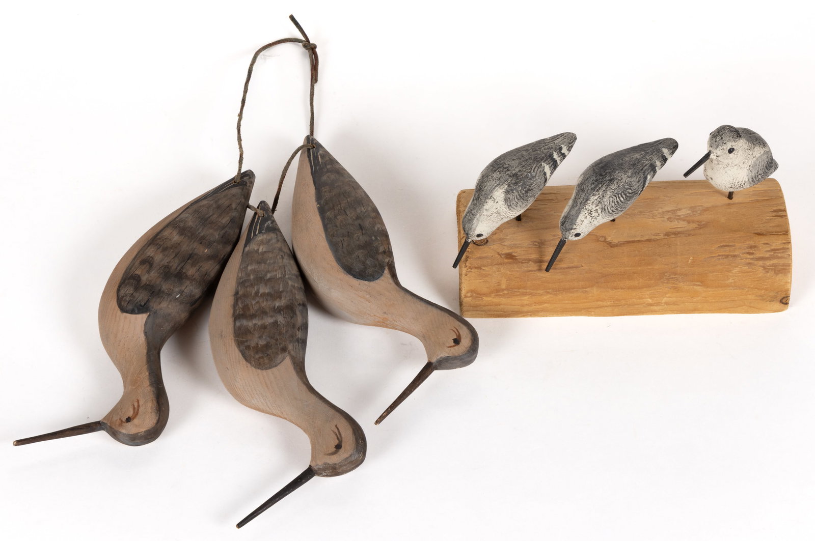 AMERICAN FOLK ART CARVED AND PAINTED SHOREBIRD DECOYS, LOT OF FOUR: AMERICAN FOLK ART CARVED AND PAINTED SHOREBIRD DECOYS, LOT OF FOUR, comprising three Sanderlings presented on a driftwood stand, and a rig of three Yellowlegs decoys. Fourth quarter 20th century.