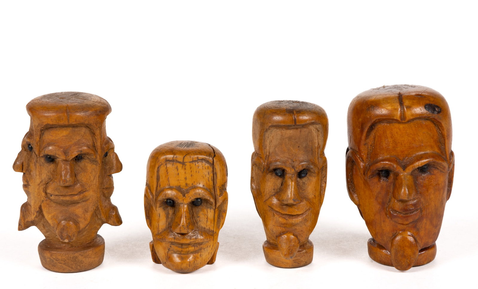 AMERICAN FOLK ART CARVED FIGURAL CARNIVAL CANE GRIPS, LOT OF FOUR: AMERICAN FOLK ART CARVED FIGURAL CARNIVAL CANE GRIPS, LOT OF FOUR, maple and hickory/oak, each probably carved by the same hand, one example having only a single face, two having two faces, and one ha