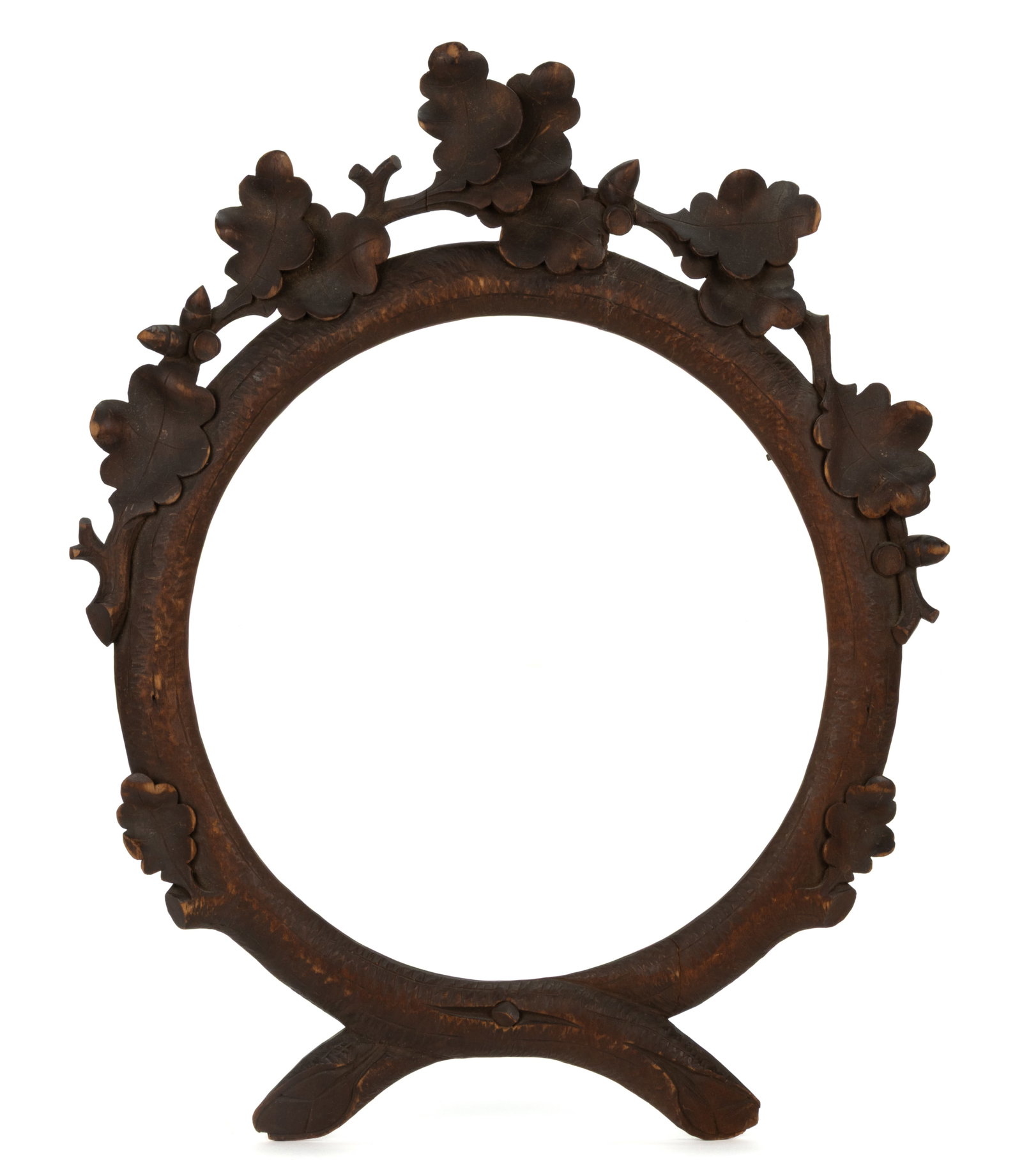 GERMAN / SWISS BLACK FOREST CARVED FRAME: GERMAN / SWISS BLACK FOREST CARVED FRAME, poplar or a similar softwood, the round faux-bois naturalistic frame features a crest of oak leaves and crossing branches at the bottom. Retains the original 