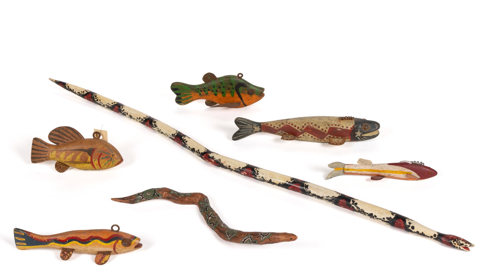 ASSORTED FOLK ART CARVED AND PAINTED WOODEN FIGURAL FISH AND SNAKES, LOT OF SEVEN: ASSORTED FOLK ART CARVED AND PAINTED WOODEN FIGURAL FISH AND SNAKES, LOT OF SEVEN, comprising of five various fish, each with various painted decorations, each having metal fins and several with 