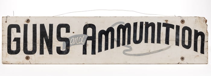 AMERICAN FOLK ART PAINTED POPLAR GUNS AND AMMUNITION TRADE SIGN