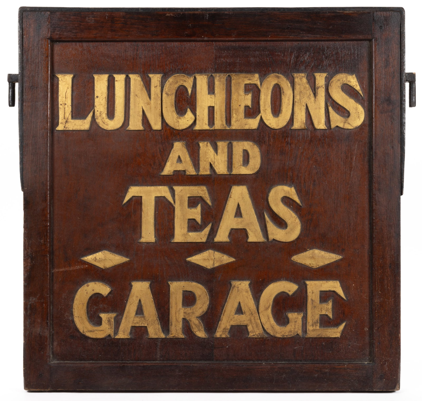 AMERICAN FOLK ART PAINTED WOODEN AND CAST IRON TRADE SIGN: AMERICAN FOLK ART PAINTED WOODEN AND CAST IRON TRADE SIGN, square double-sided wooden sign with raised painted lettering reading "LUNCHEONS AND TEAS", "GARAGE"; top of sign has a c