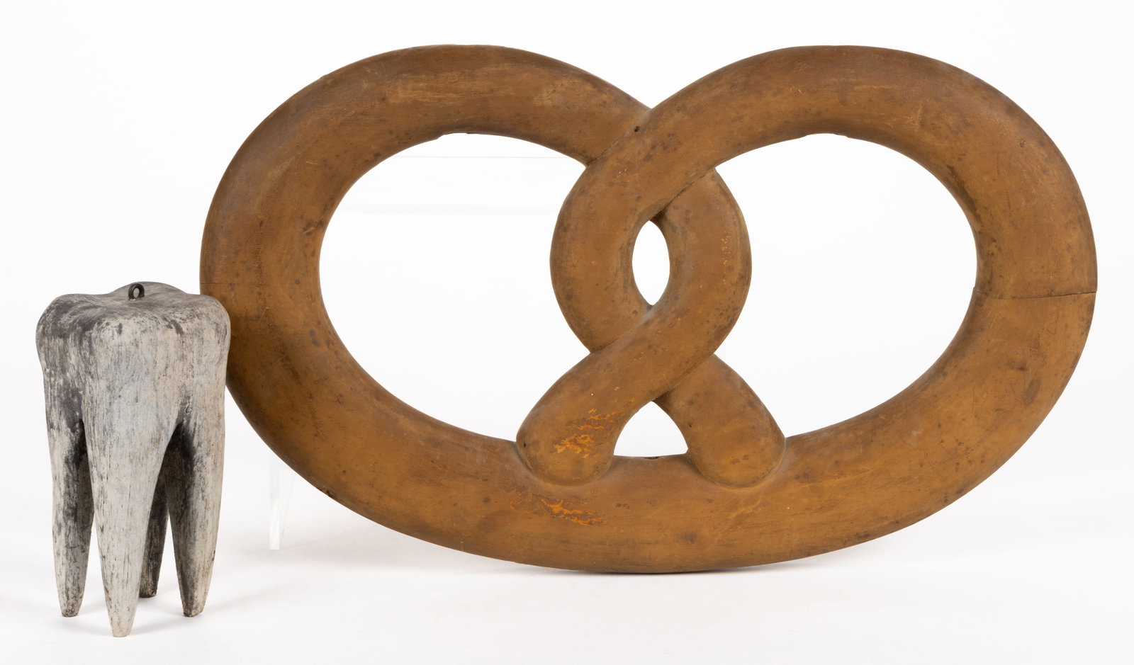 AMERICAN FOLK ART WOODEN TRADE SIGN ATTACHMENTS, LOT OF TWO: AMERICAN FOLK ART WOODEN TRADE SIGN ATTACHMENTS, LOT OF TWO, comprising one tooth (molar), painted white with a small eye hook at the top, and one pretzel painted brown with two holes at the top and o