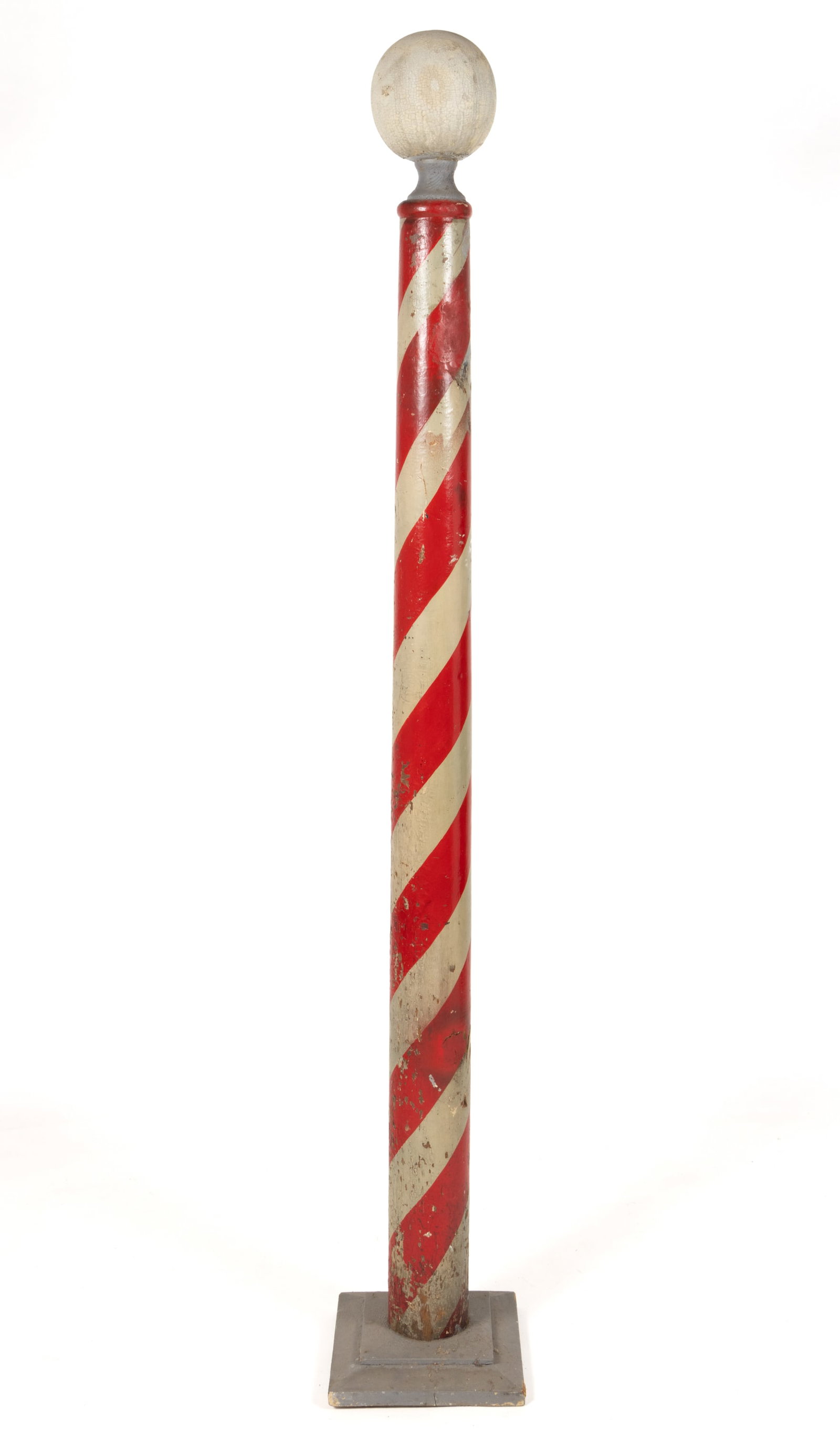 AMERICAN FOLK ART TURNED AND PAINTED WOODEN BARBER'S POLE: AMERICAN FOLK ART TURNED AND PAINTED WOODEN BARBER'S POLE, with oversized finial and old red-and-white surface, presented on possibly later wooden stand. Late 19th/first quarter 20th century. 88&q