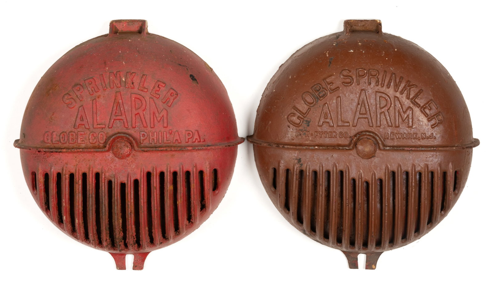 VINTAGE CAST-IRON SPRINKLER ALARM BELL COVERS, LOT OF TWO: VINTAGE CAST-IRON SPRINKLER ALARM BELL COVERS, LOT OF TWO, comprising one Globe Co, Philadelphia, PA example and one Fyr-Fyter Co., Newark, N.J. 20th century. 15 1/2" D. Provenance: From th