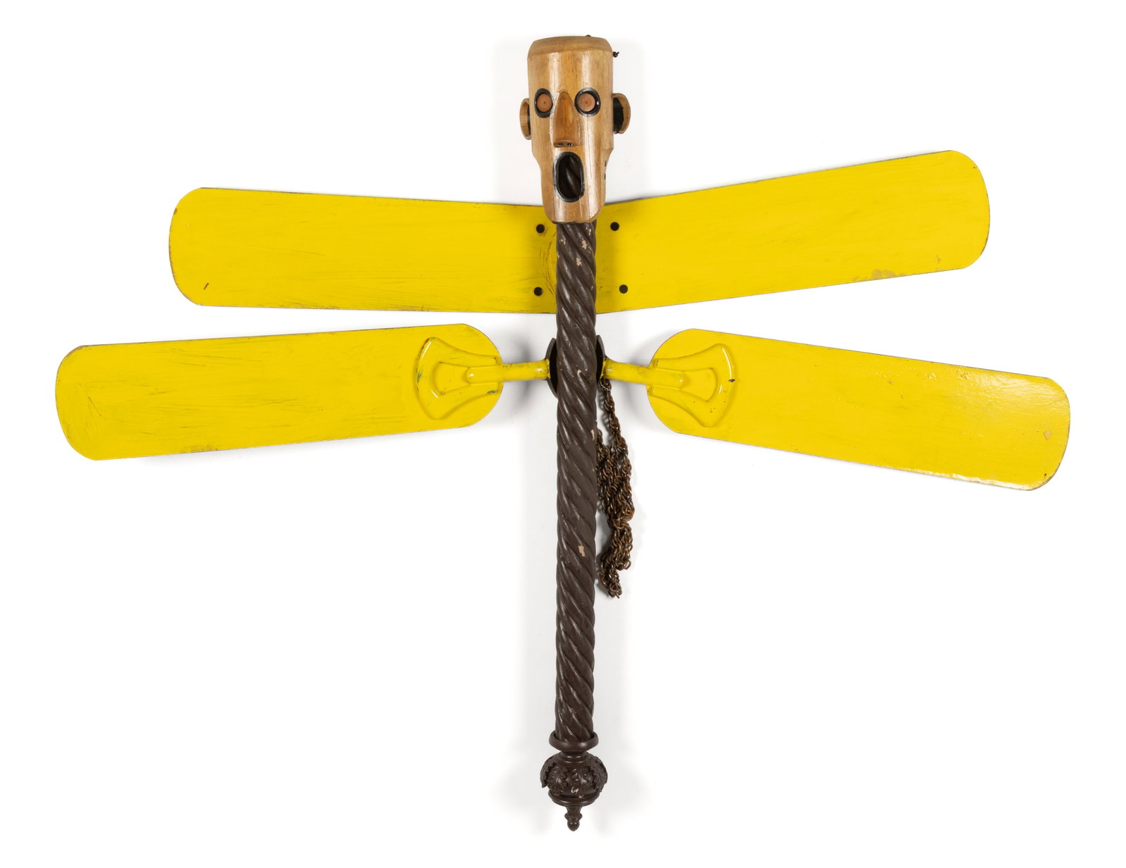 RALPH BATTEN (AMERICAN, ACTIVE 20TH/21ST CENTURY) OUTSIDER ART DRAGONFLY SCULPTURE: RALPH BATTEN (AMERICAN, ACTIVE 20TH/21ST CENTURY) OUTSIDER ART DRAGONFLY SCULPTURE, constructed of found parts, depicting a dragonfly-like creature with a mask face and yellow-painted fan-blade w