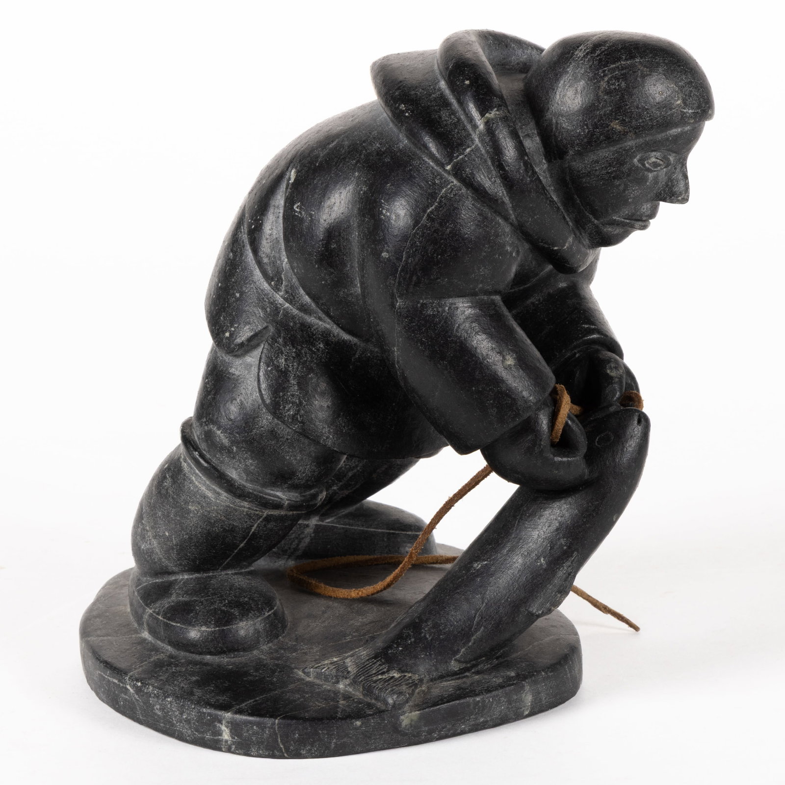 AISARA NUVALINGA NUNGA (CANADIAN INUIT, PUVIRNITUQ, 1923-D) CARVED SOAPSTONE FIGURE: AISARA NUVALINGA NUNGA (CANADIAN INUIT, PUVIRNITUQ,1923-D) CARVED SOAPSTONE FIGURE, depicting a hunter with a newly caught fish hooked by a leather thong, underside inscribed with disc