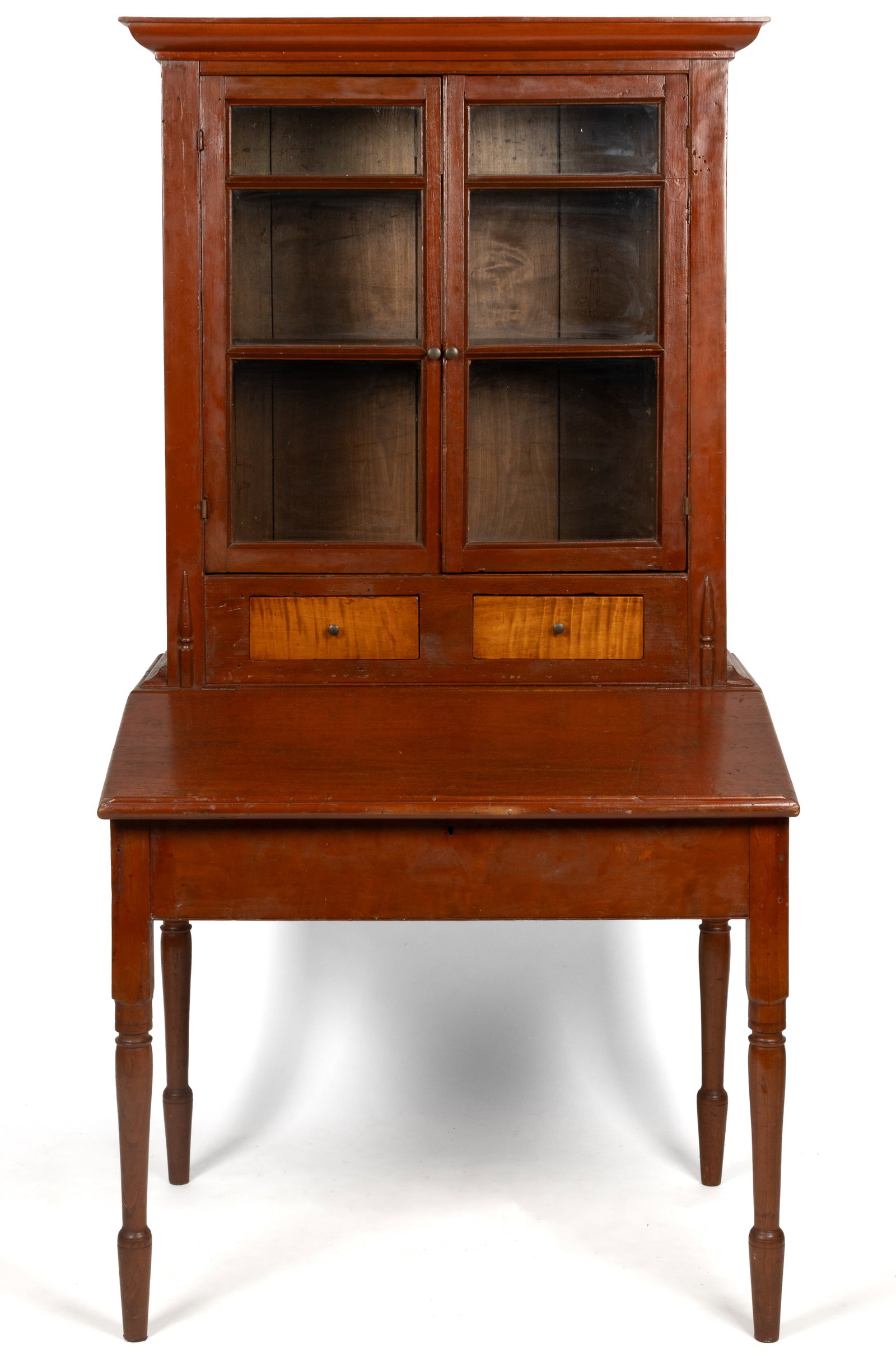 MID-ATLANTIC CHERRY AND TIGER MAPLE PLANTATION DESK: MID-ATLANTIC CHERRY AND TIGER MAPLE PLANTATION DESK, single-piece form, featuring a deep overhanging cornice over two glazed cabinet door concealing two fixed shelves, two short drawers with tiger map
