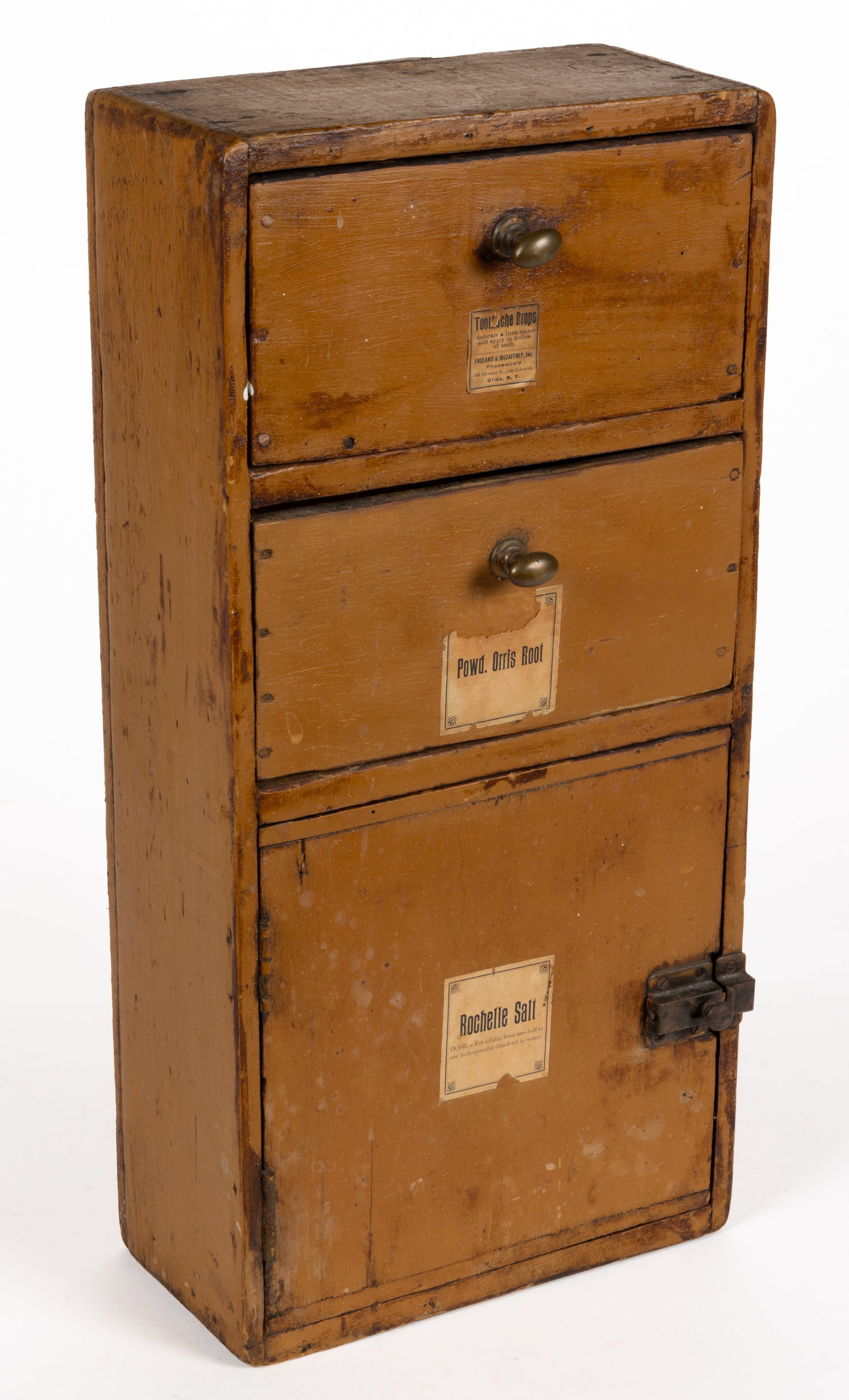 DIMINUTIVE NEW YORK STATE PAINTED PINE APOTHECARY CUPBOARD: DIMINUTIVE NEW YORK STATE PAINTED PINE APOTHECARY CUPBOARD, hanging form of nailed construction featuring two drawers over a hinged cabinet door, each bearing a period printed label, the upper ex