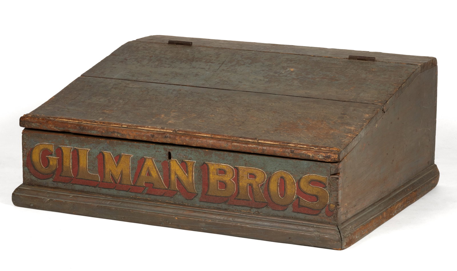 AMERICAN PAINT-DECORATED PINE COUNTRY-STORE COUNTERTOP DESK: AMERICAN PAINT-DECORATED PINE COUNTRY-STORE COUNTERTOP DESK, featuring a hinged slanted front with an applied molded edge over a fitted interior with cubbies at the rear, and robust base