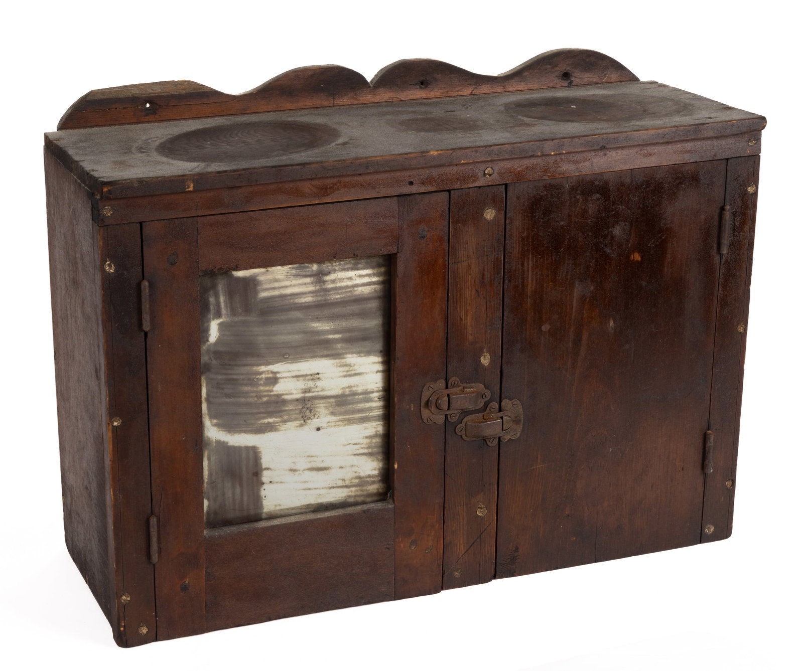AMERICAN COUNTRY HANGING MEDICINE CABINET: AMERICAN COUNTRY HANGING MEDICINE CABINET, shaped top, two compartments each with a hinged door; one door has a likely original mirror. The mirrored compartment has one fixed shelf, and the other